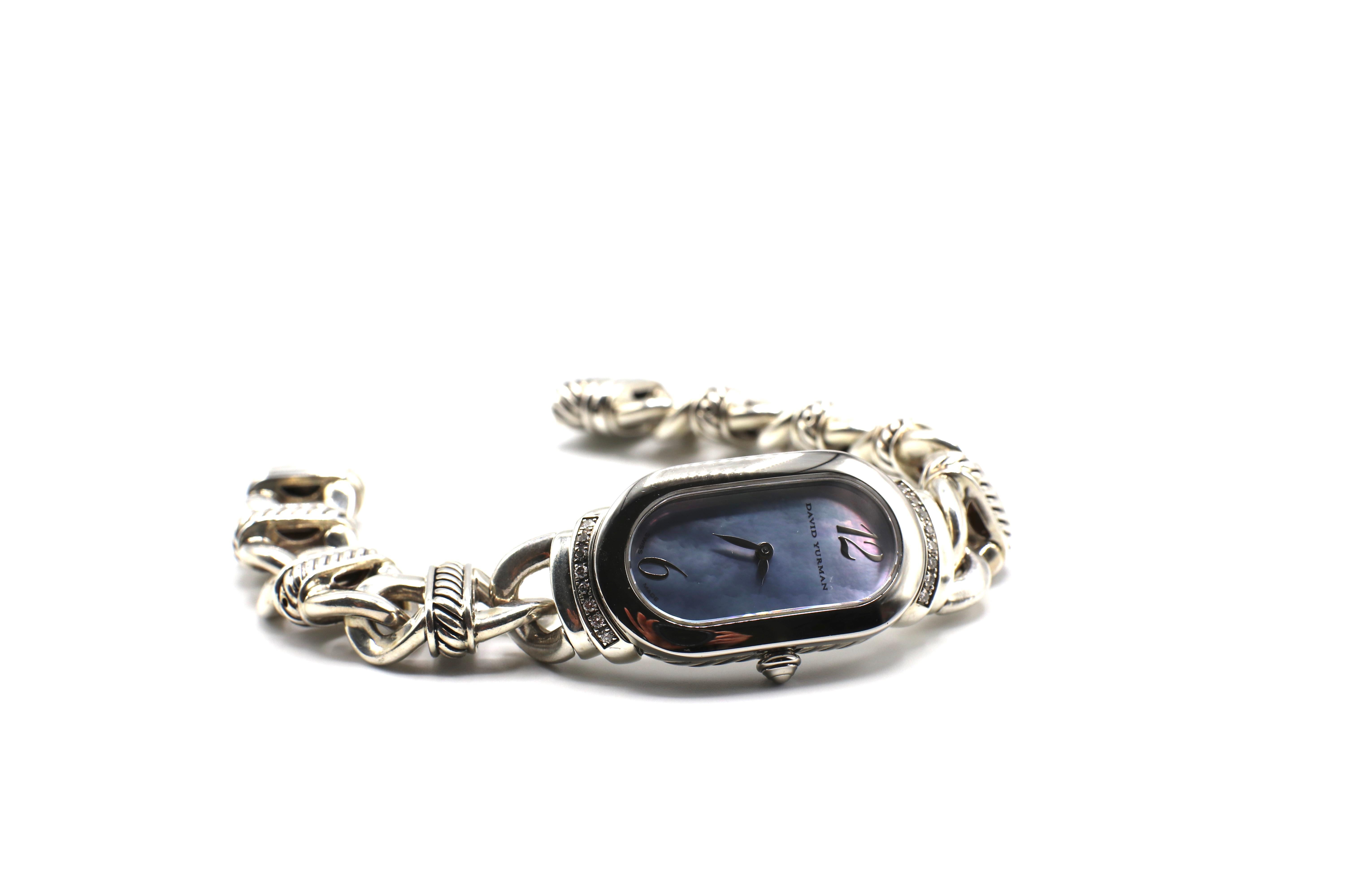 For sale is a David Yurman Watch from the Madison collection with a blue Mother of Pearl dial and Diamond accents of round diamonds, approx. 0.16 CTW G VS. The metal is a combination of Sterling Silver and Stainless Steel. The model for this watch
