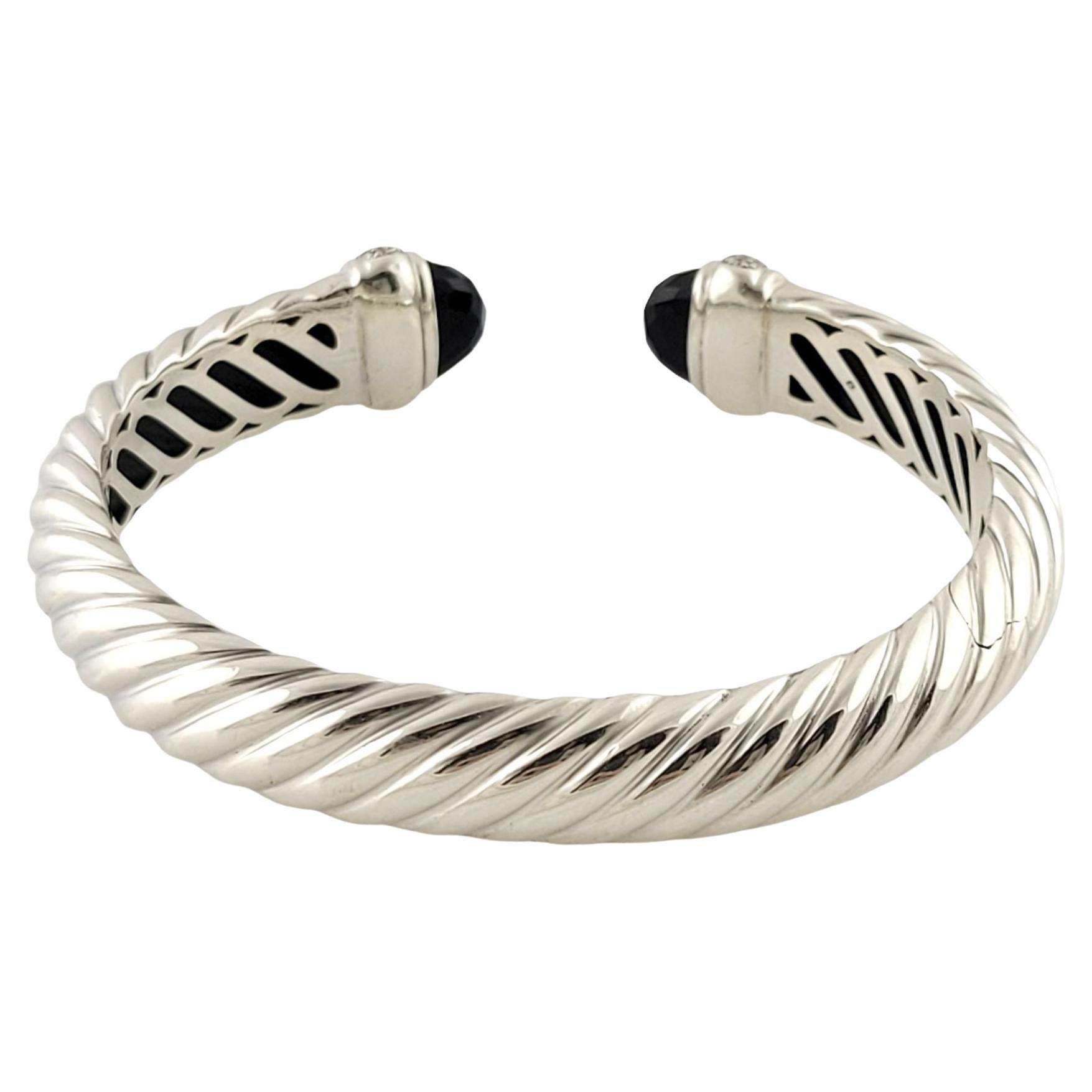 David Yurman Sterling Silver Black Onyx and Diamond Waverly Cuff Bracelet-

This elegant cuff bracelet by David Yurman is crafted in beautifully detailed sterling silver and features two faceted onyx gemstones accented with 80 round brilliant cut