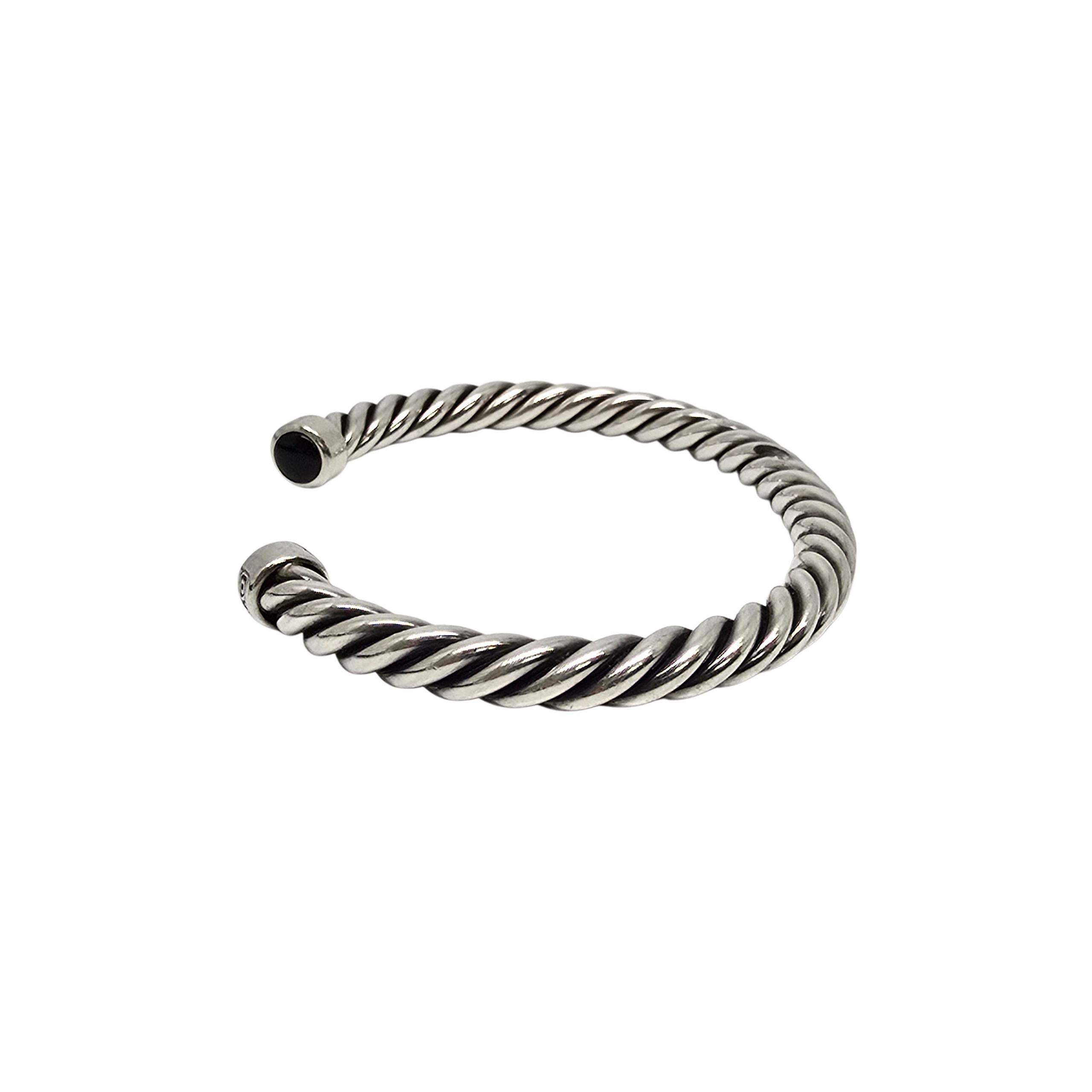 David Yurman sterling silver onyx men's Cable Cuff Bracelet.

David Yurman's classic and iconic twist design cuff bracelet featuring black onyx end caps.

Weighs approx 40.g, 26.3dwt

Measures approx 7 1/2