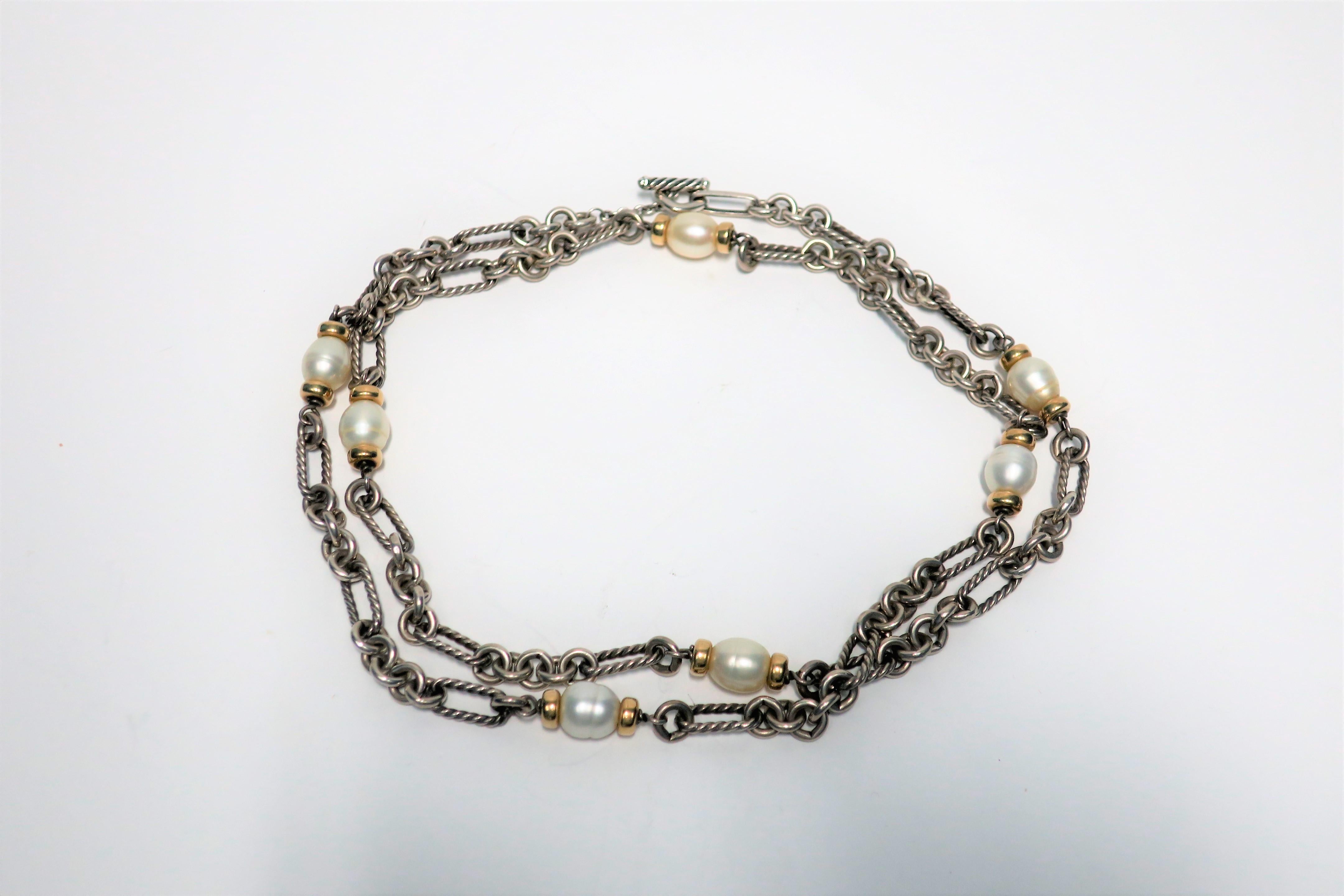 A beautiful and substantial vintage David Yurman 'Figaro' necklace, circa early-21st century, around 2002. Necklace is comprised of substantial sterling silver links and large freshwater pearls embraced by 18-karat yellow gold accent beads, with