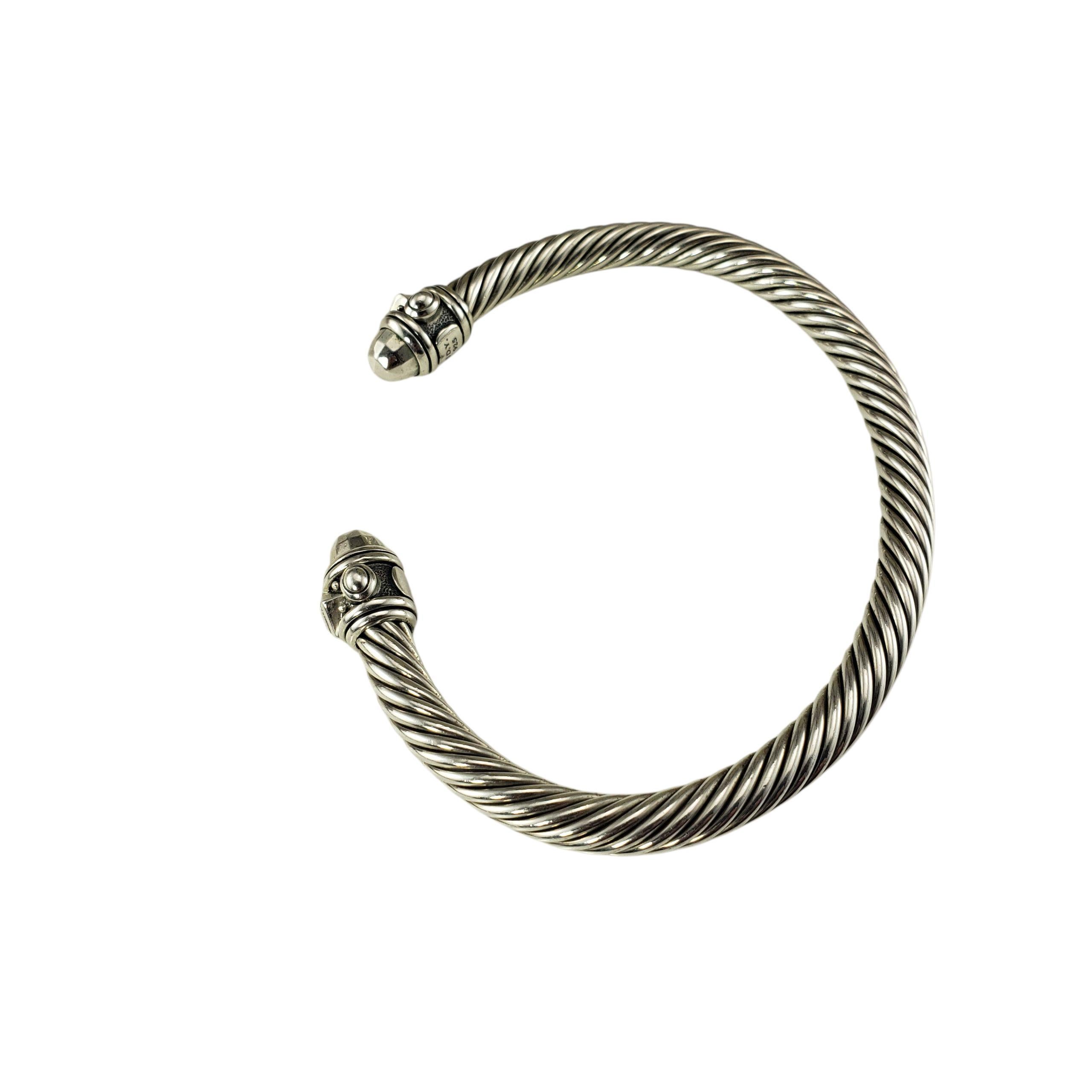 David Yurman Sterling Silver Renaissance Cuff Bracelet-

This elegant sterling silver cuff bracelet by David Yurman features the brand's signature twisted cable design and Renaissance style end caps. A timeless classic that can be worn solo or
