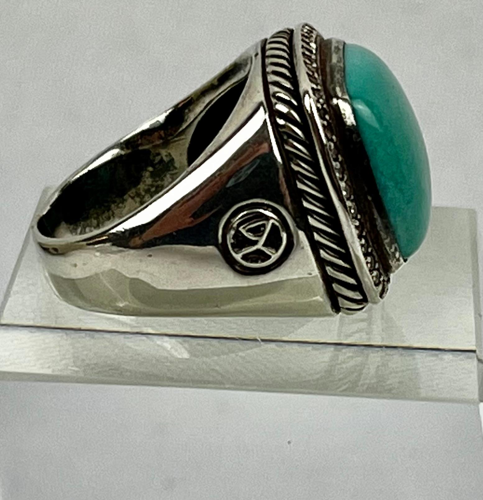 Sterling silver ring by David Yurman.  The stone is a square cut cabochon turquoise surrounded by 42 full cut diamonds approximately .75 points each.  It is approximately a size 9.
This ring can be sized.
Weight- 14.7 grams or .51 troy ounces