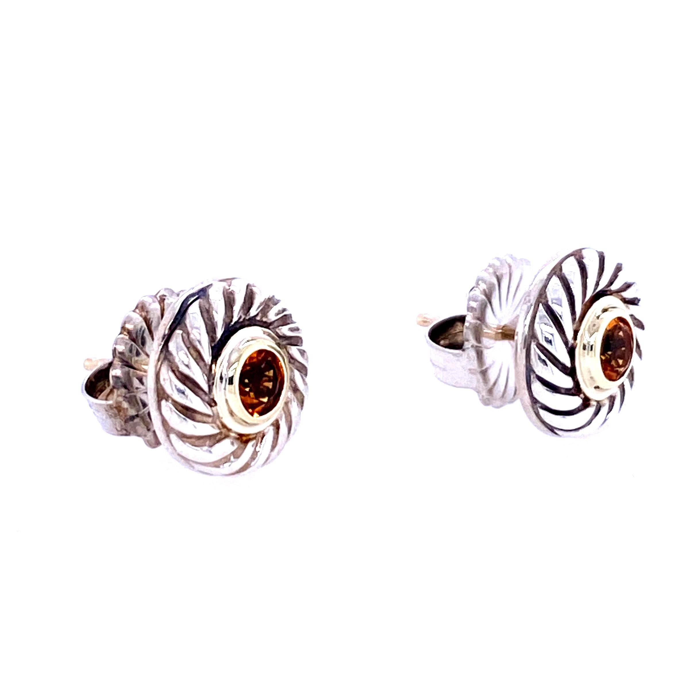 One pair of sterling silver (stamped 925 D.Y. 585) David Yurman earrings, each set with one 4mm round citrine in a yellow gold bezel setting.  The earrings measure 11.5mm in diameter and have friction fat backs and posts.  