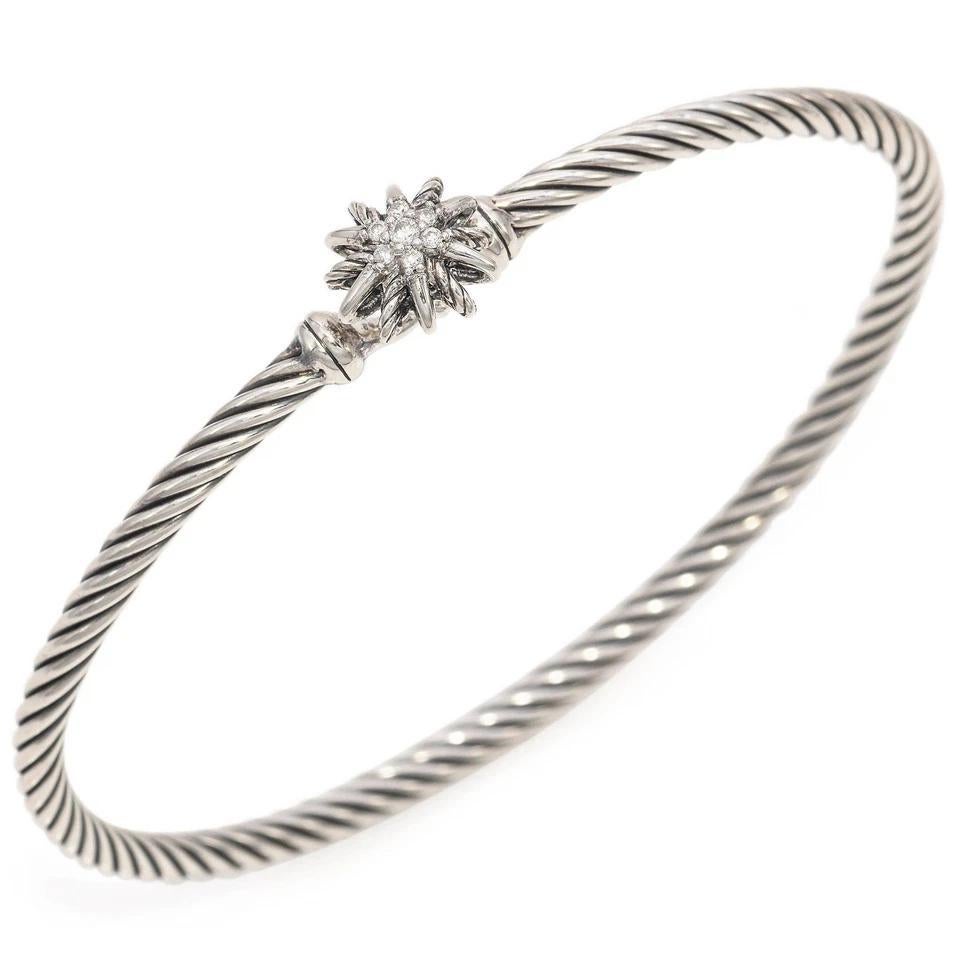 Elevate your accessory game with the exquisite David Yurman Sterling Silver Bracelet, featuring a stunning cushion-cut garnet at its center. This luxurious piece is adorned with sparkling round brilliant diamonds, totaling 0.06ct, adding a touch of