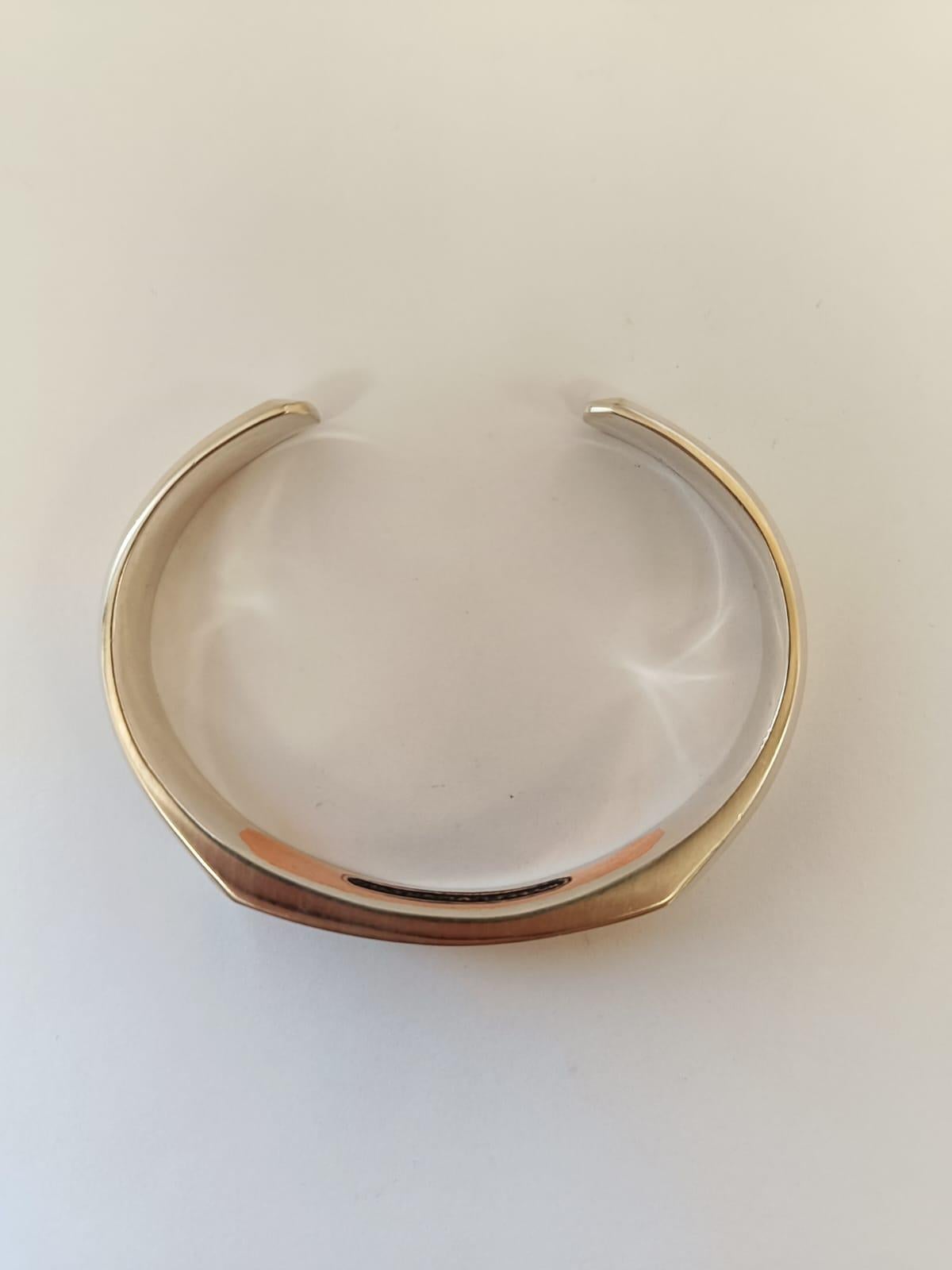 David Yurman Streamline Cuff Bracelet
Inspired by clean lines and smooth metal surfaces, these minimalist designs are sculpted with engineered precision.
•	Sterling silver & copper 
•	Bracelet, 9.5 mm
•	Size fits wrists up to 7.9 in