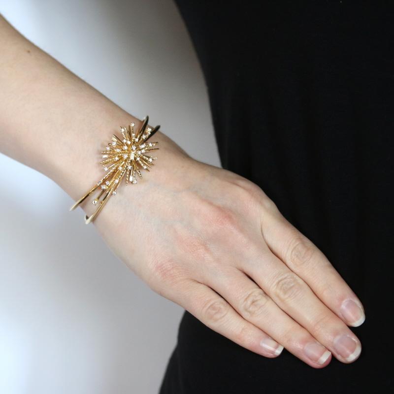 Retail Price: $8,500

Brand: David Yurman
Collection: Supernova

Metal Content: 18k Yellow Gold

Stone Information
Natural Diamonds
Total Carats: .72ctw
Cuts: Baguette & Round Brilliant
Color: G - H
Clarity: VS1 - VS2

Style: Cuff 
Fastening Type: