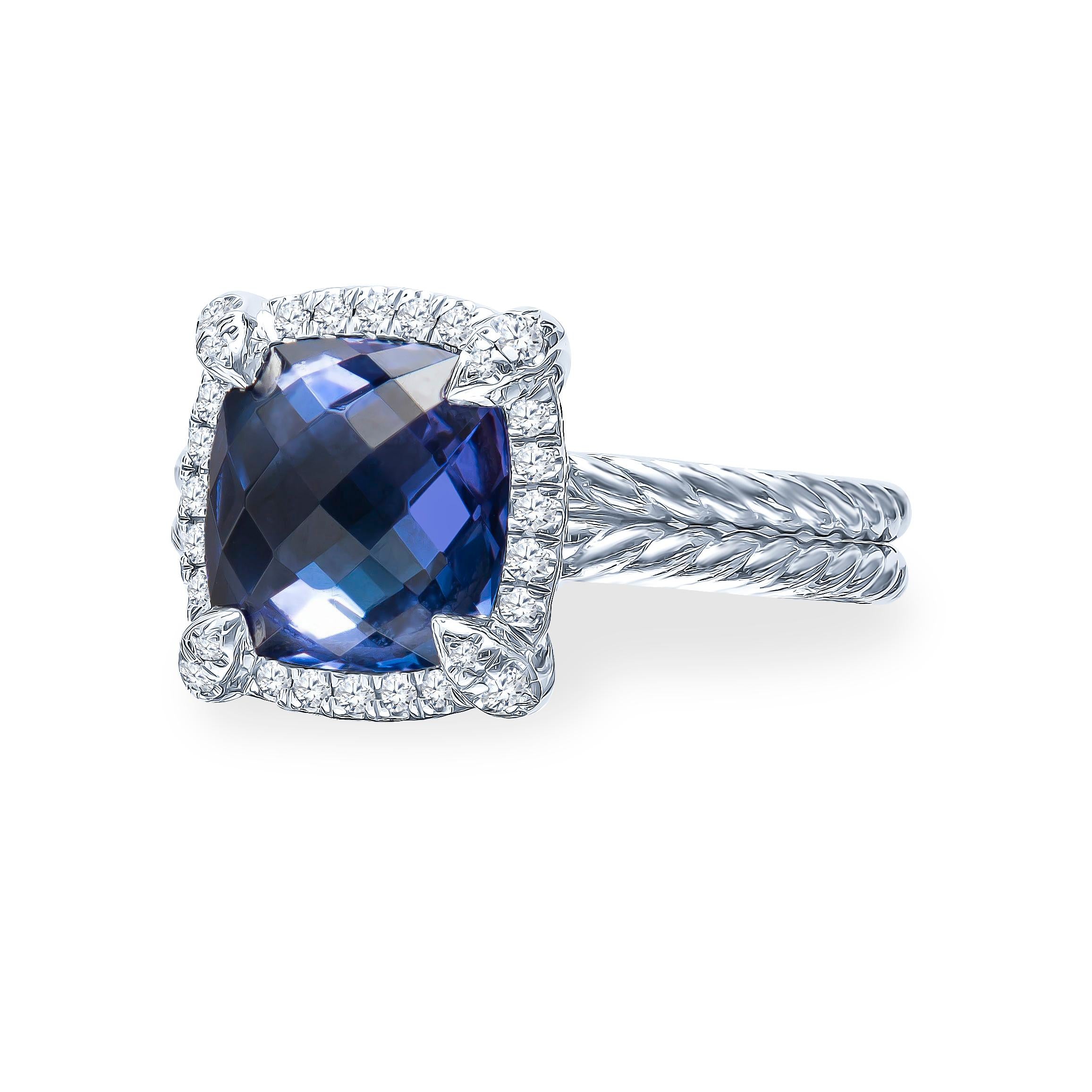 This classic David Yurman ring features a faceted tanzanite with 0.15 carats total of pave-set accent diamonds that surround the stone. Made in 18K white gold with a double spiral band that is a size 6. Comes with original David Yurman box.