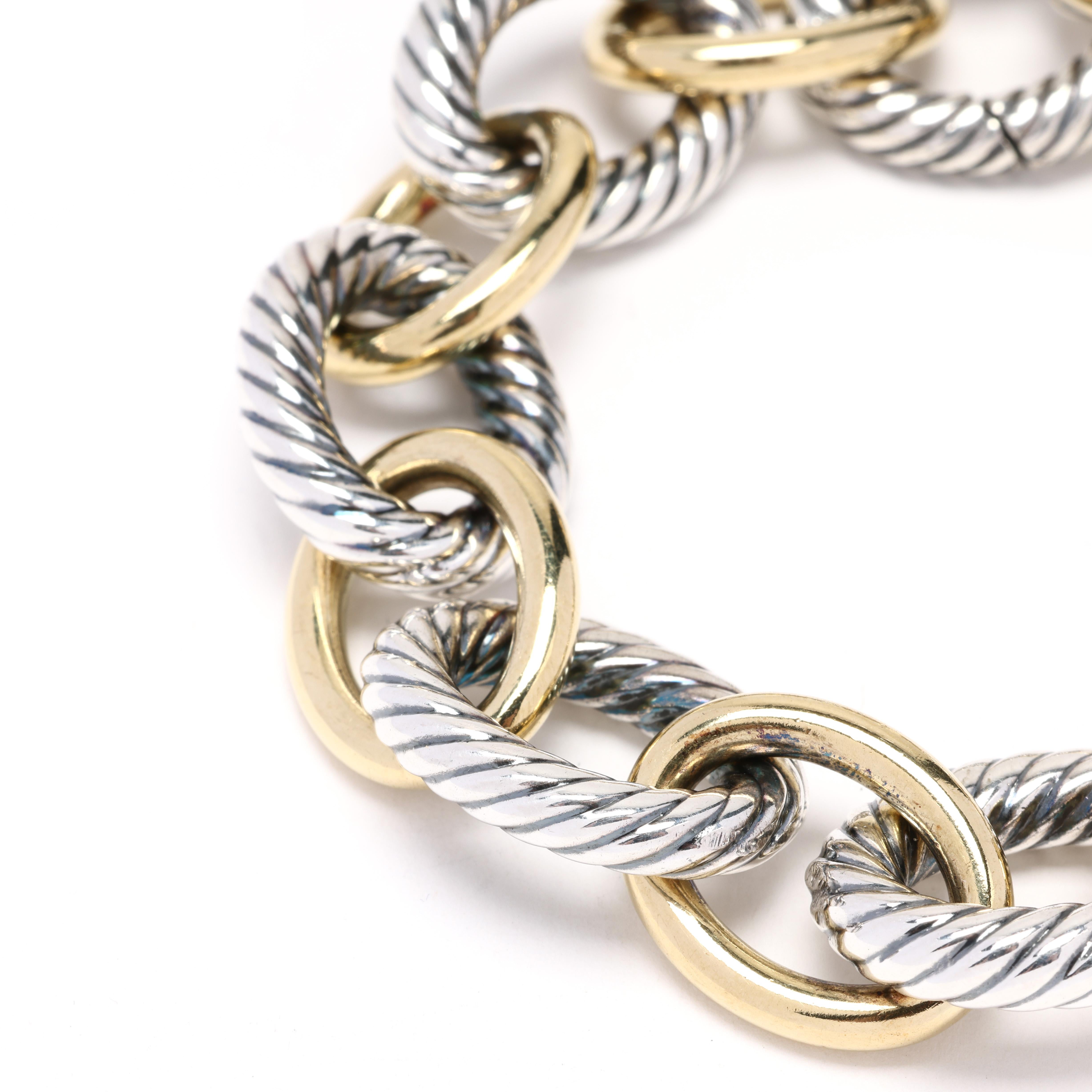 This David Yurman thick link bracelet is a stunning and bold statement piece. Made from 18k yellow gold and sterling silver, this bracelet features a thick and textured link design that is sure to catch everyone's attention. The combination of 18k