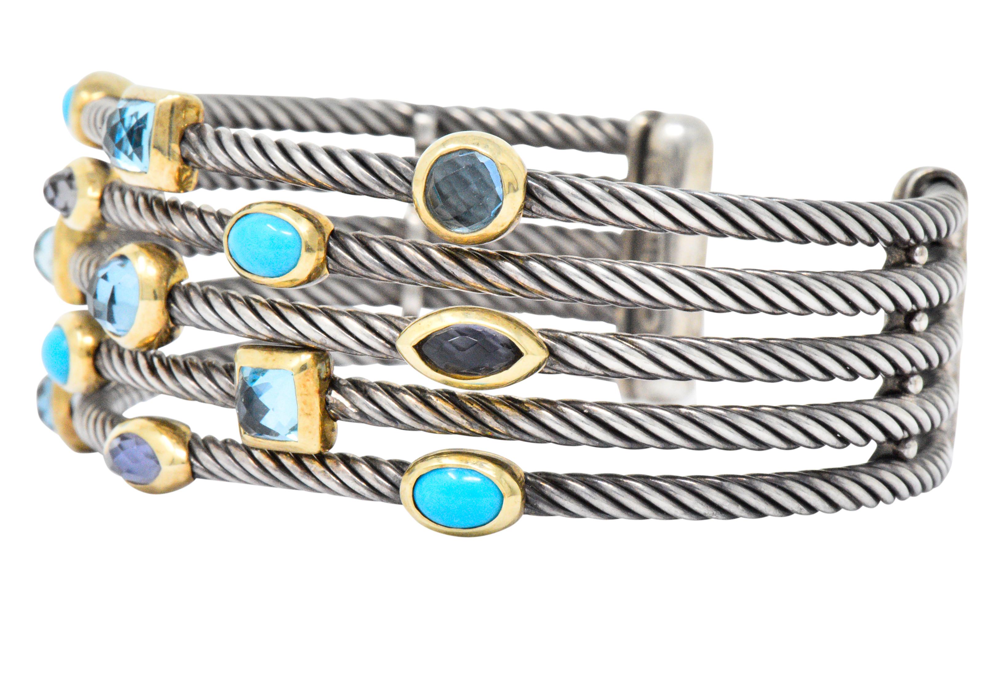 Wide cuff style bracelet comprised of five sterling silver twisted cable segments

Set throughout by turquoise, iolite, and blue topaz - each cabochon cut or checkerboard cut and bezel set in gold

Terminates as polished sterling silver