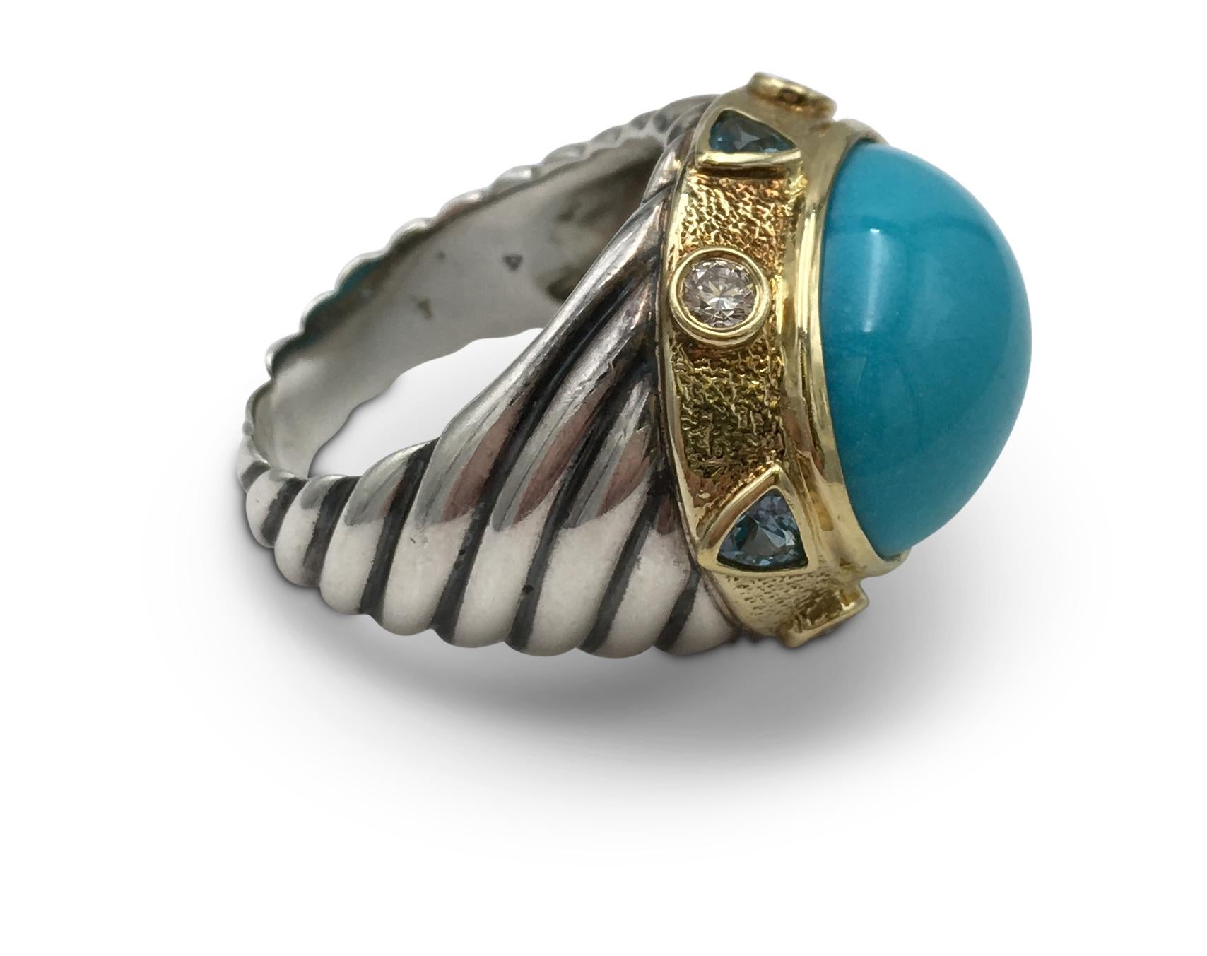 Authentic David Yurman ring crafted in sterling silver with 18 karat yellow gold. The ring centers on a large smooth oval cabochon shaped turquoise stone surrounded by four triangular blue zircon stones and round brilliant cut diamonds weighing