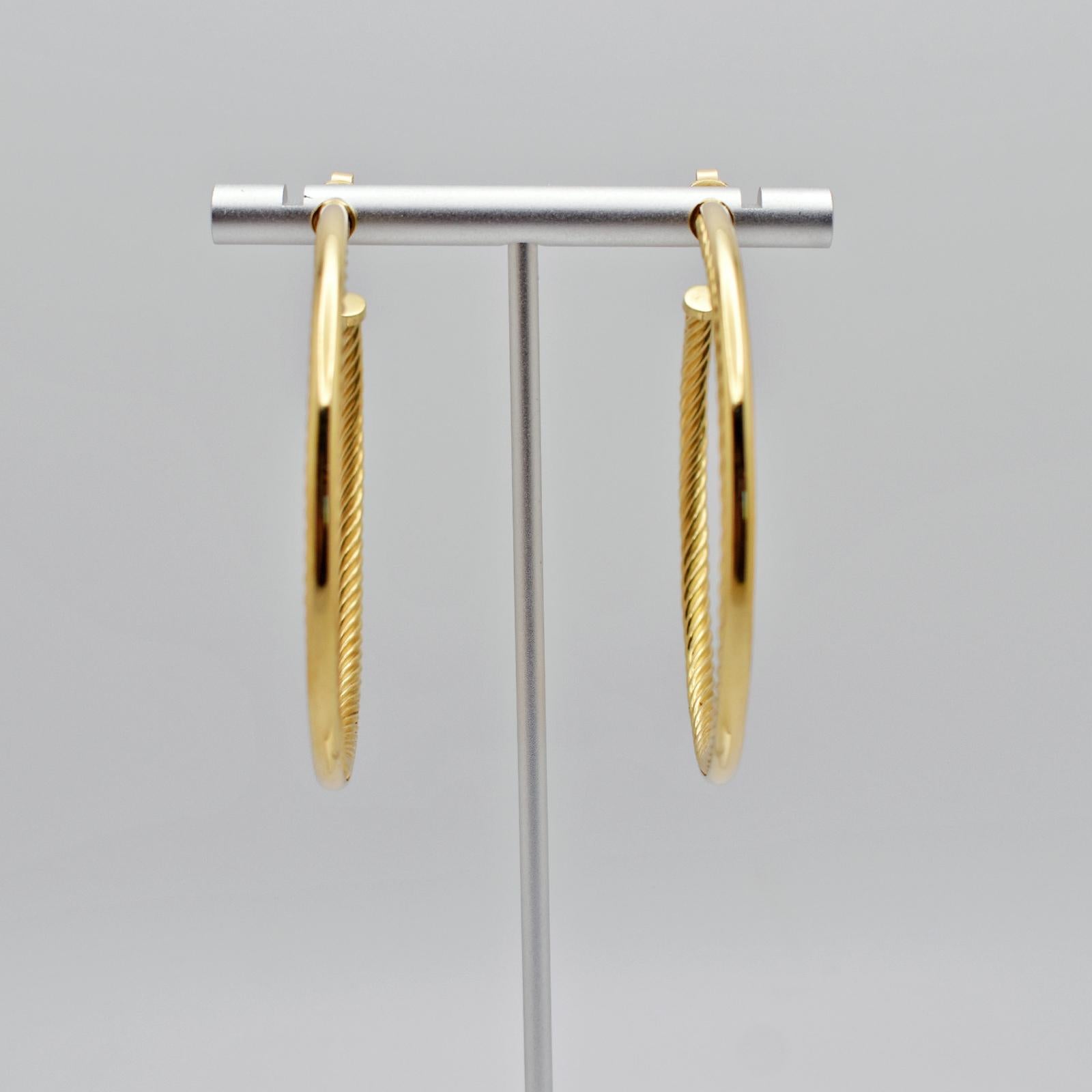 Rich, 18k yellow gold twisted hoop earrings made by designer David Yurman. The modern and minimalist style make these earrings the perfect staple for your jewelry box. They are ideal for casual, daily wear, and are also versatile enough to be worn