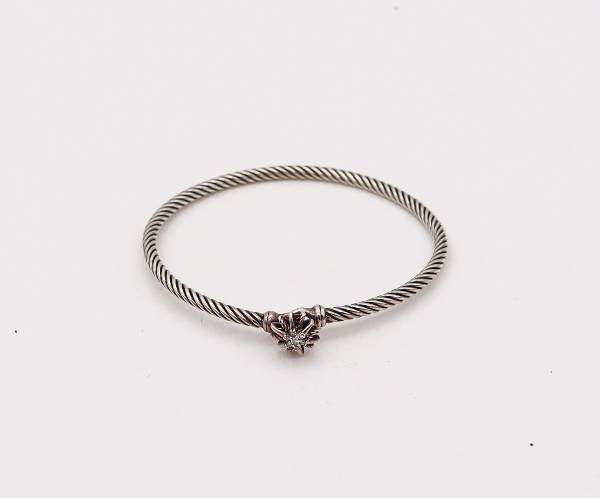 Twisted bangle bracelet designed by David Yurman.

An iconic bangle bracelet from the starburst collection, created by David Yurman. It was crafted with twisted wires made up in solid .925/.999 sterling silver with a starburst in the center. Mounted