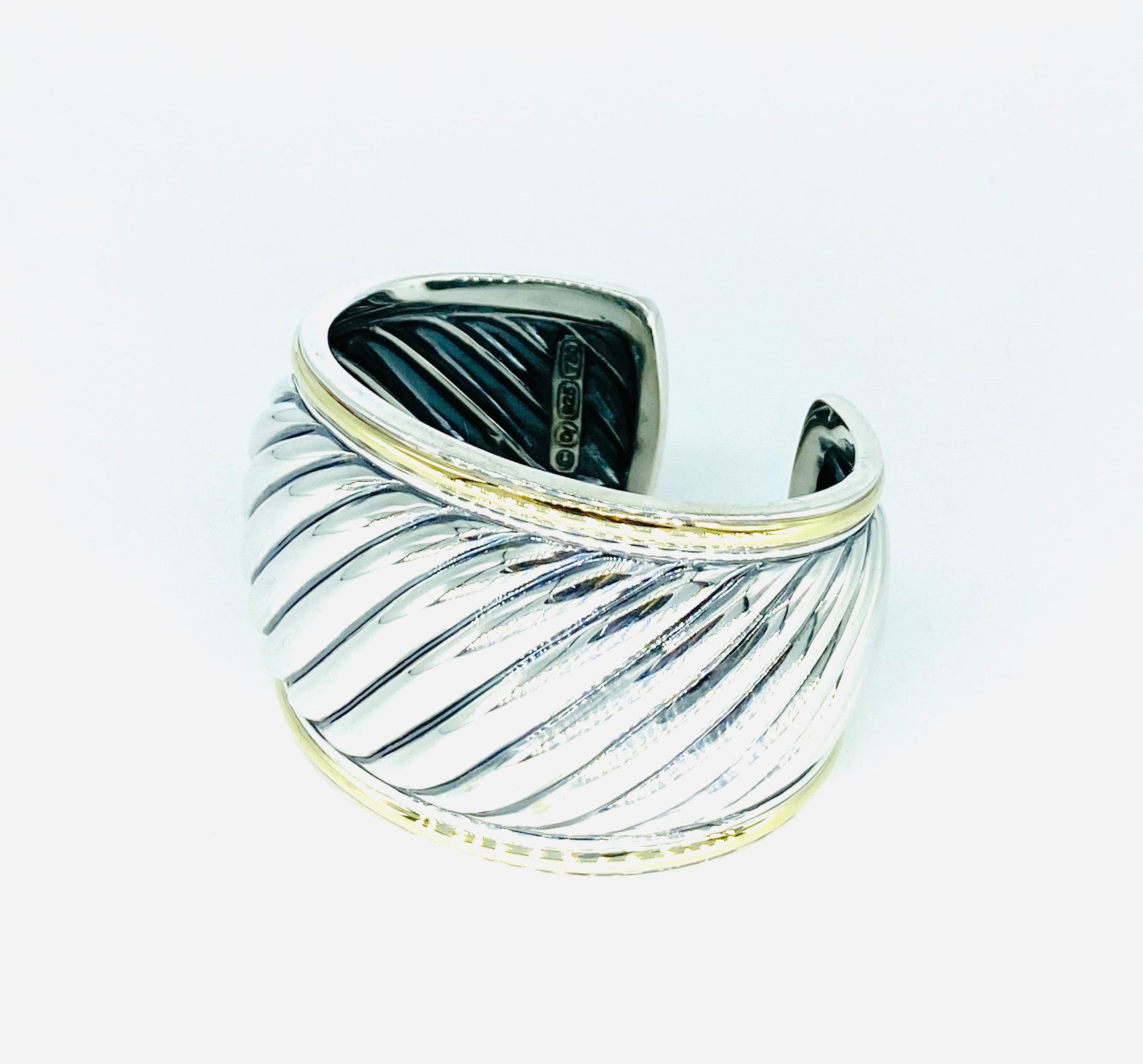 David Yurman Wide Two-Tone Sterling Silver & 18k Gold Cuff Cable Bangle. Beautiful bangle by famous designer David Yurman. You can see by the design why it is so sought after. Just incredible piece you stay amazed staring at. The bangle weights 66