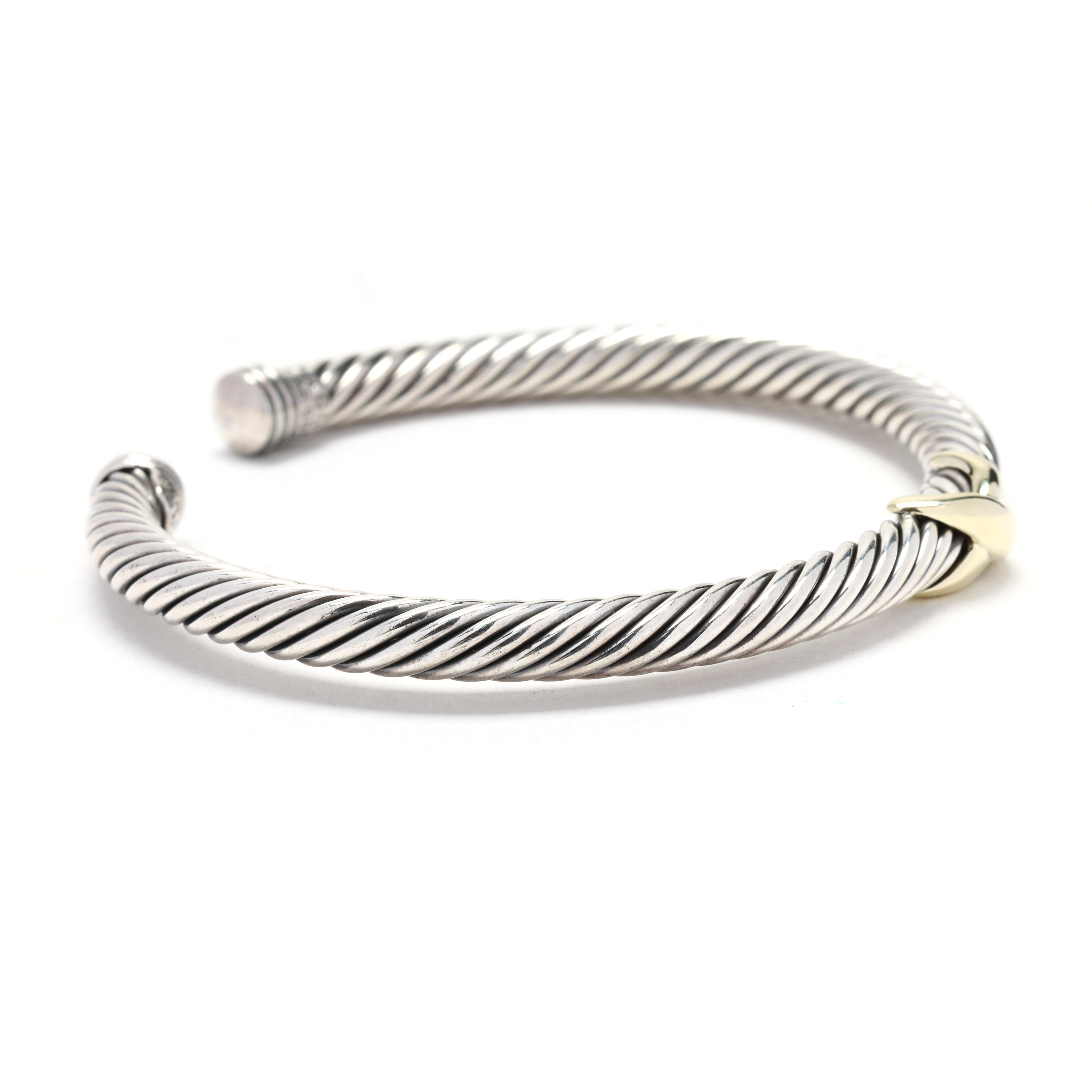This beautiful David Yurman X Collection cuff bracelet is made from 14k yellow gold and sterling silver. The cuff features a unique X design, with one side in yellow gold and the other in silver. The combination of the two metals creates a bold and