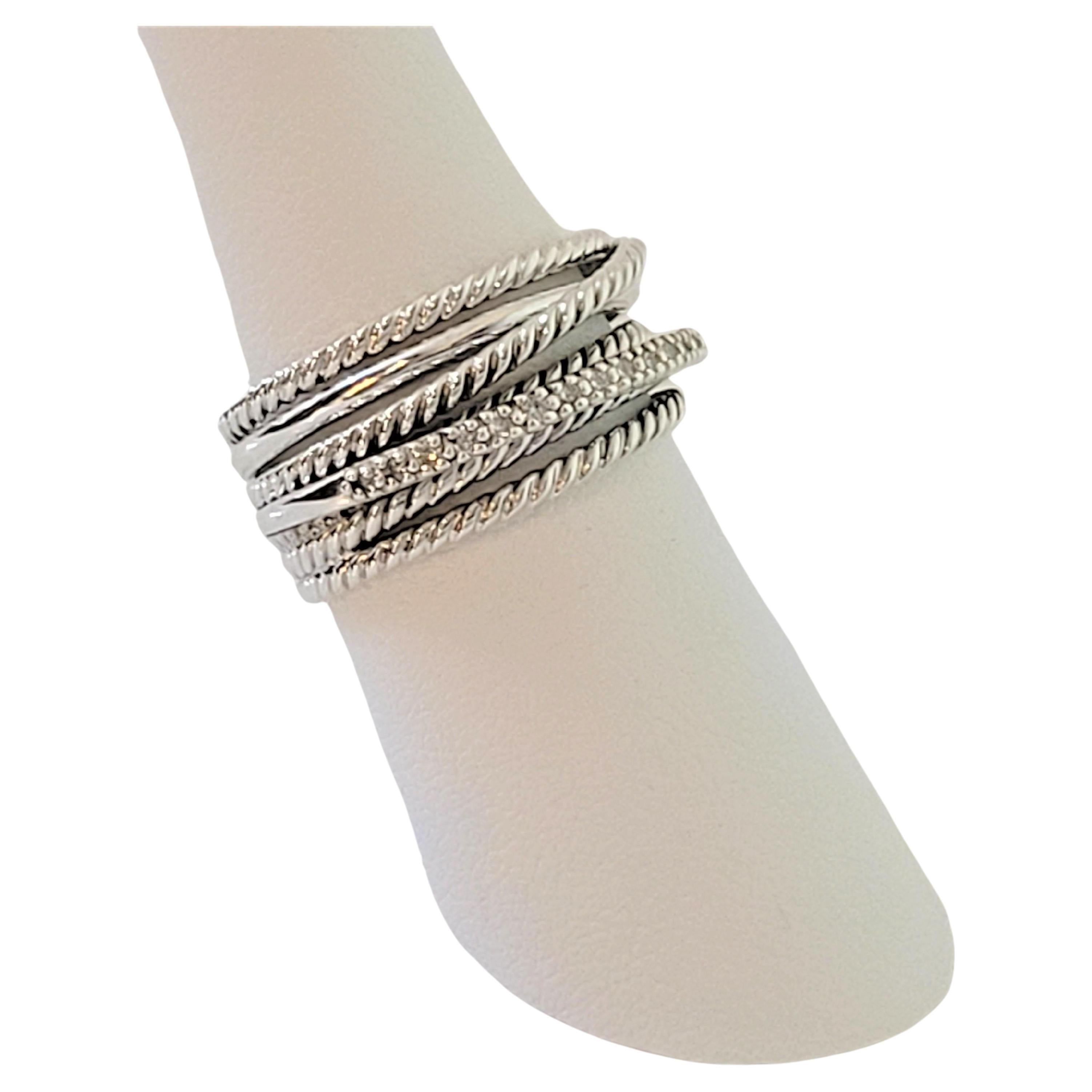 David Yurman Crossover ring 
Material Sterling Silver
Pave-set diamonds 0.18 total carat weight 
The Stamps ''D.Y.'' and ''925''
Weight 7.8gr 
Ring Size 8
Gender women
Condition New, never worn
Comes with David Yurman ring box
