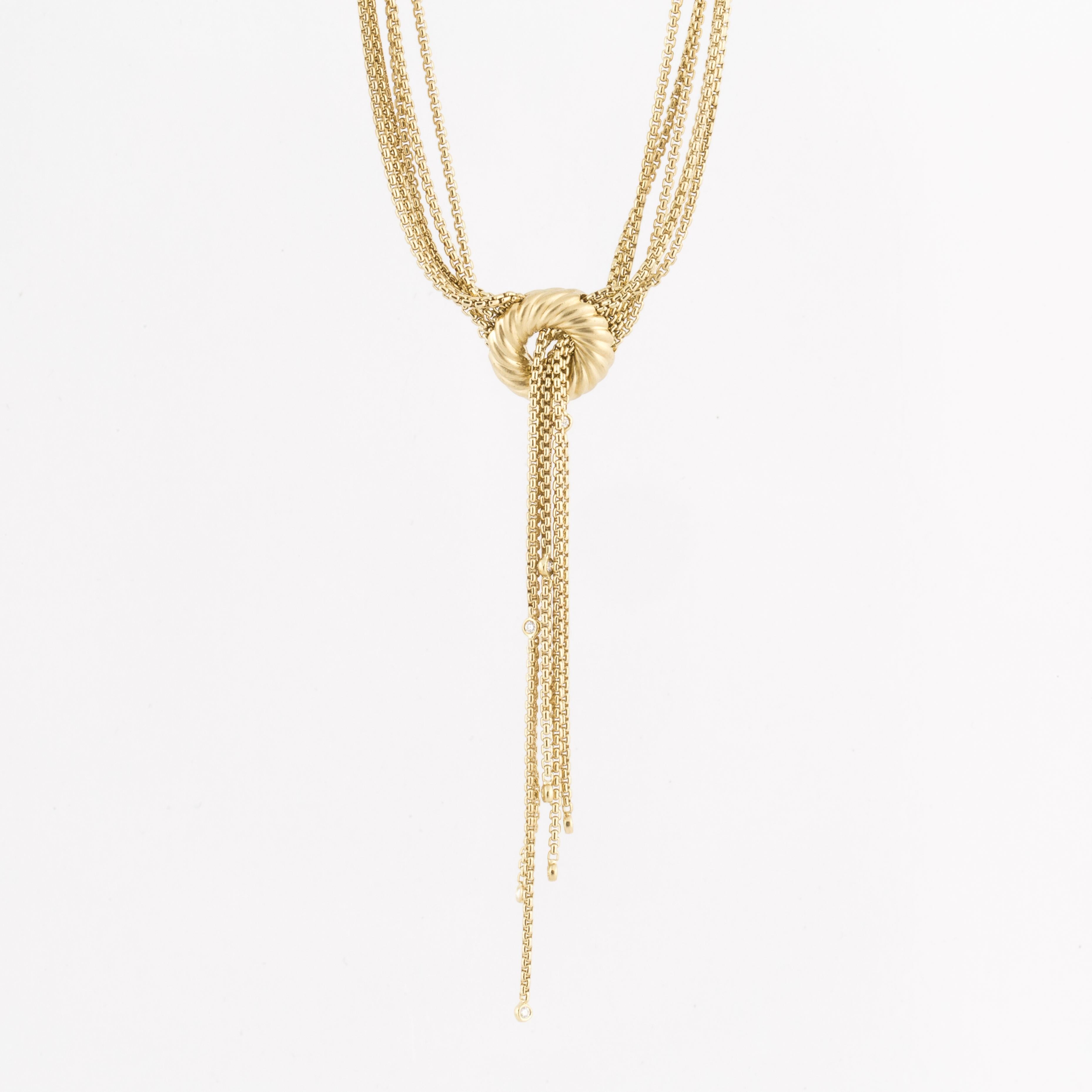 David Yurman 18K yellow gold multi strand lariat necklace.  There are six chains with a small diamond at the bottom of each one.  Circle pendant measures 3/4 inches across.  Length is 17 inches at the longest length, but is adjustable to be worn