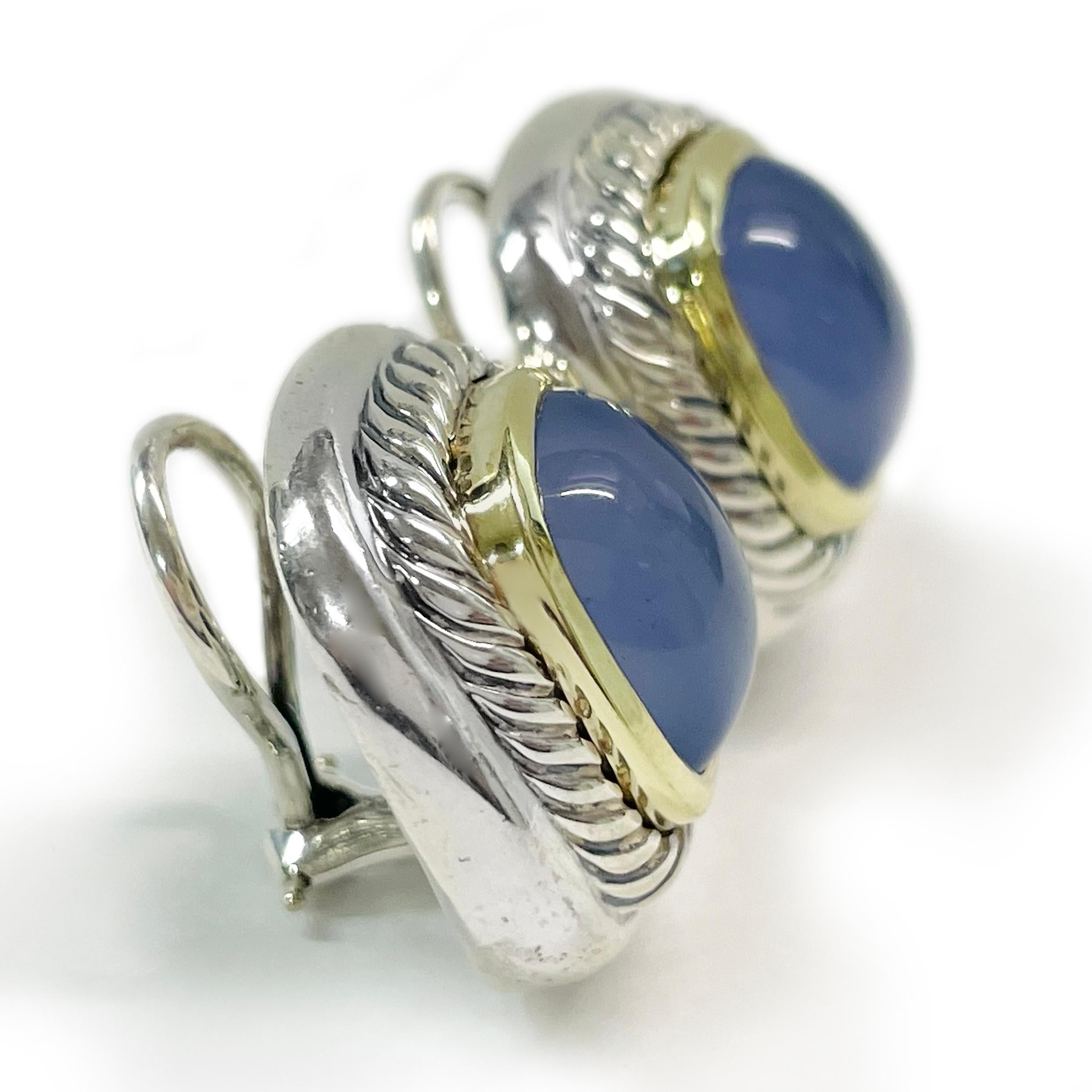 David Yurman Chalcedony Albion Clip-On Earrings. The two-tone earrings each feature a 14mm x 12mm Chalcedony cabochon, 14 karat yellow gold smooth surround and the classic Yurman cable design in sterling silver. This is a classic Yurman design that