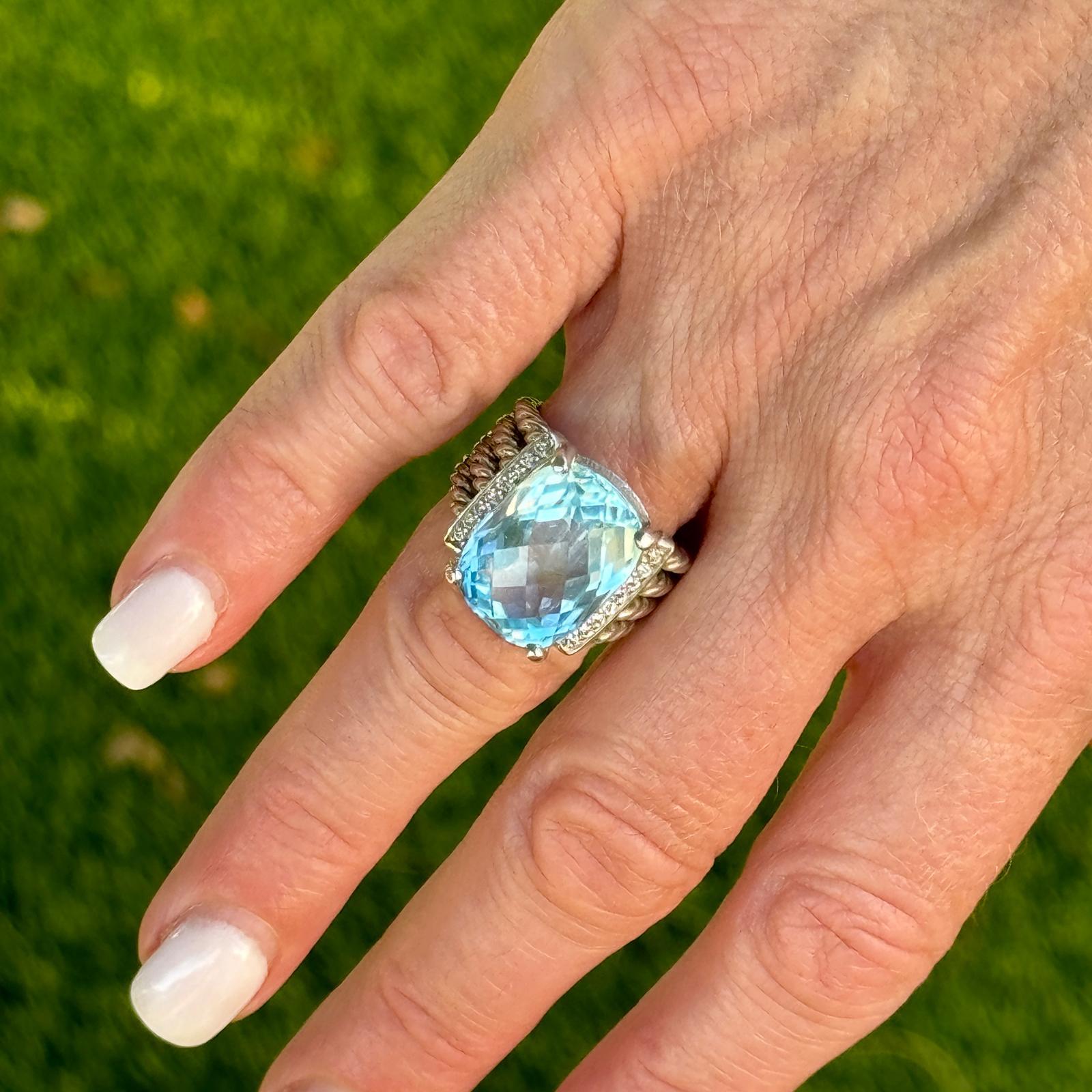 David Yurman Wheaton blue topaz and diamond ring fashioned in sterling silver. The ring features a faceted cushion cut blue topaz gemstone and round brilliant cut diamonds weighing approximately .13 CTW. The ring is currently size 6 (can be sized),