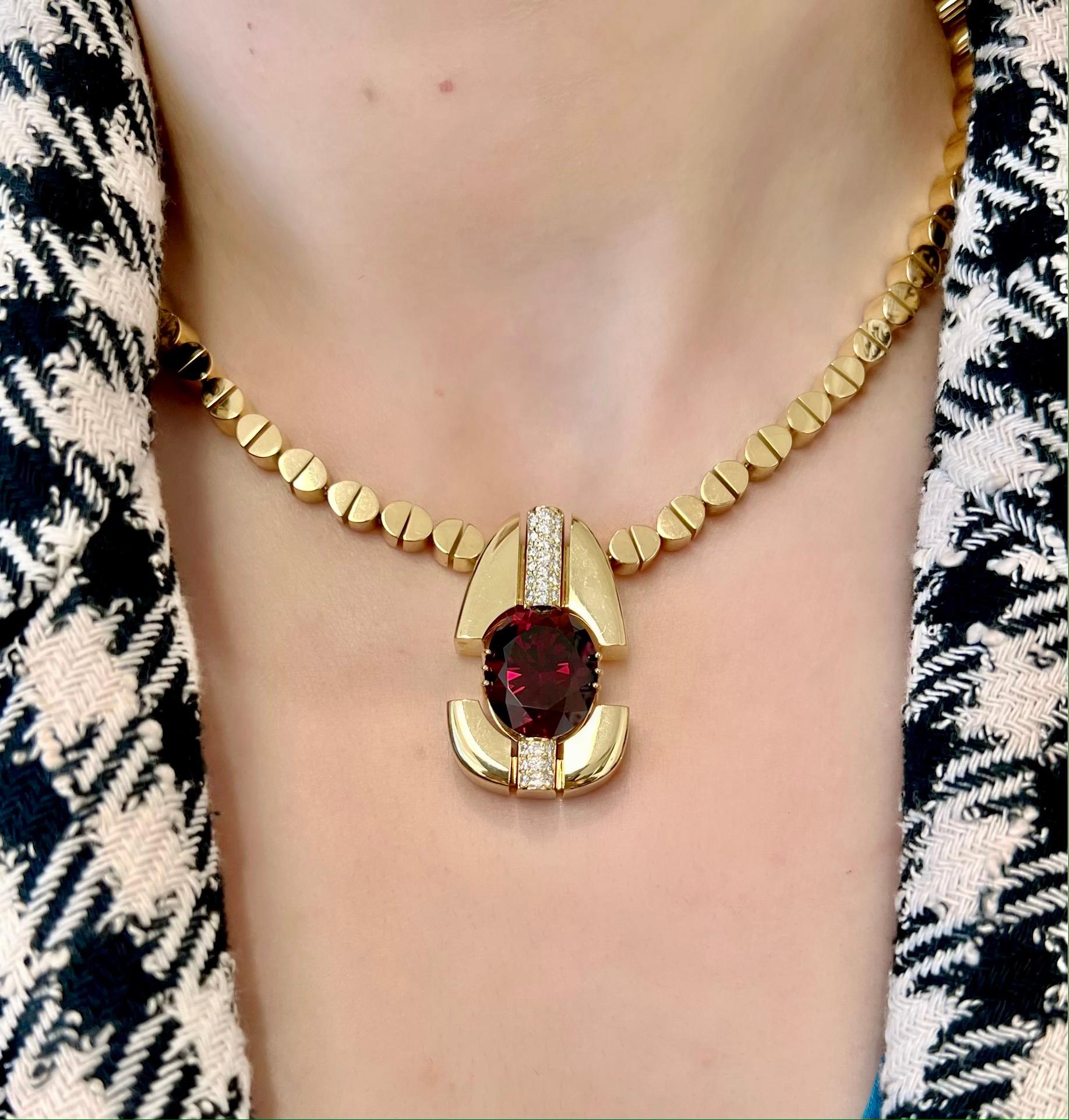 Experience luxury like never before with our unique handcrafted Rhodolite Garnet and Diamond Necklace. The pendant showcases the popular purplish-red Rhodolite garnet, named for its rosy hues in Greek. Designed by David Zoltan, this 18 karat yellow