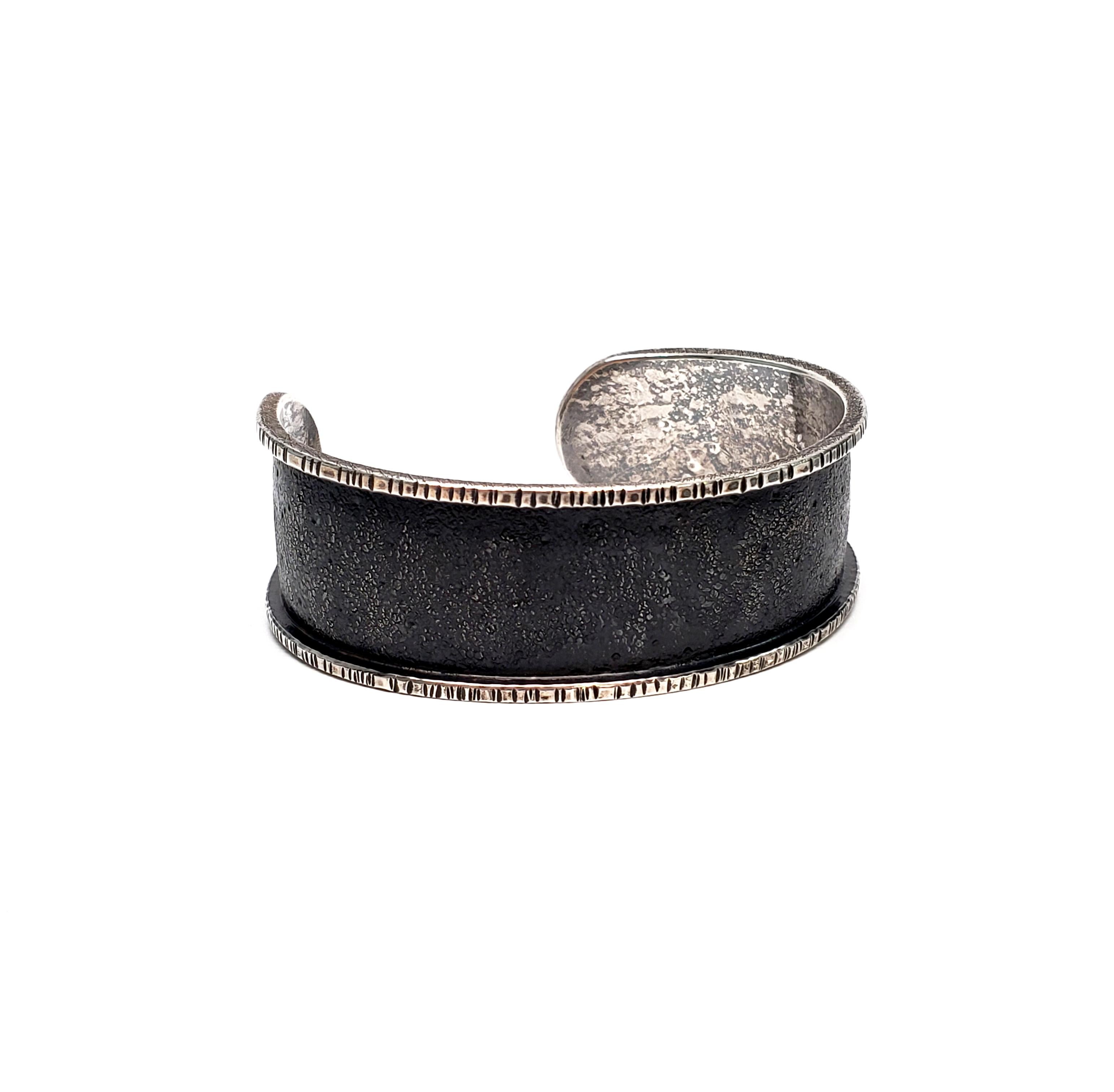 Davide Bigazzi oxidized sterling silver chased cuff bracelet.

Beautiful and unique piece handcrafted by Bigazzi, who is renowned for his mastery of chasing and repousse.

Bracelet measures 7/8