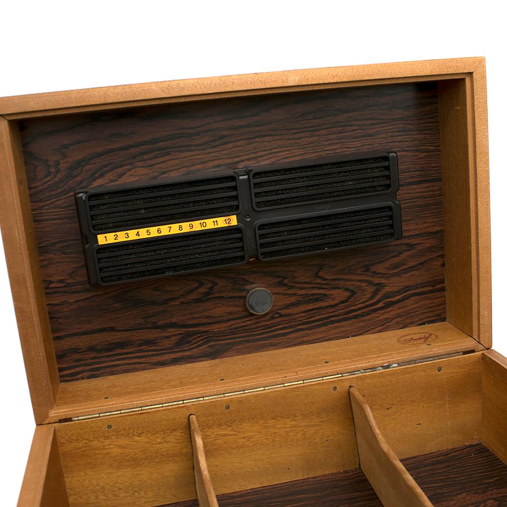 Davidoff Rose Wood Humidor

Wooden cigar box 
Three sections 
Bottle included
Filter on the top of the box 
Darker wood interior 
Cigar stop on top of the box 

Please note, these items are pre-owned and may show some signs of storage, even when