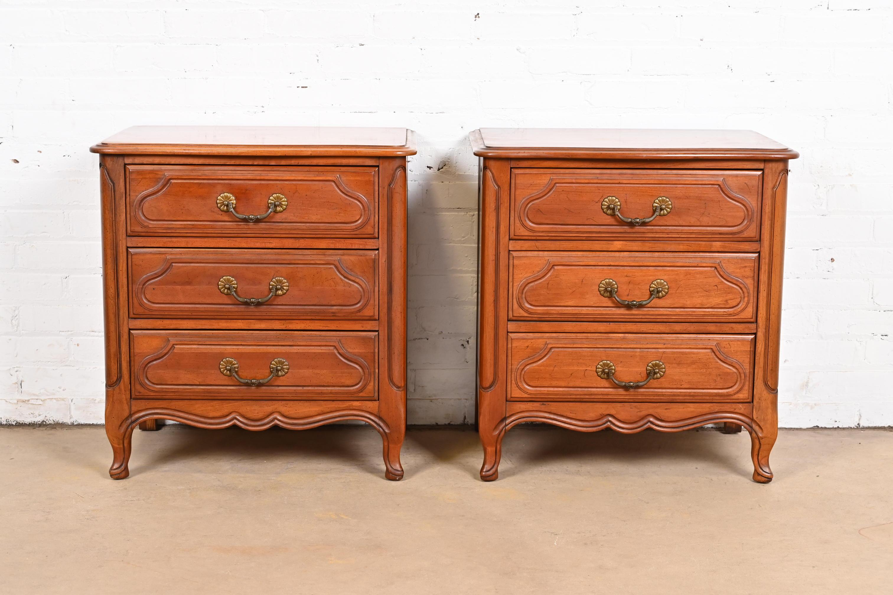 An exceptional pair of French Provincial Louis XV style three-drawer nightstands or chests of drawers

By Davis Cabinet Co.

USA, Circa 1960s

Carved solid cherry wood, with original brass hardware.

Each measures: 24.13