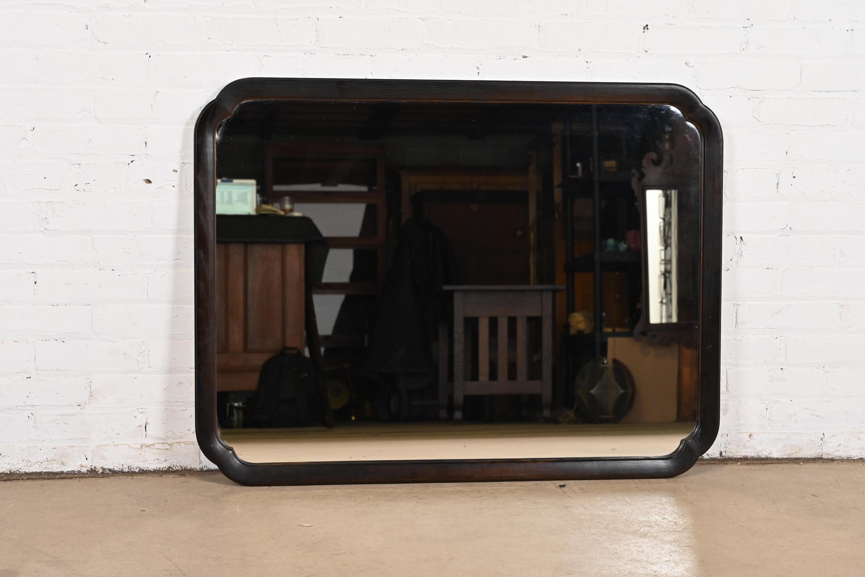 A gorgeous Mid-Century Modern Chinoiserie style ebonized ash wood framed wall mirror

By Davis Cabinet Co. 

USA, Circa 1960s

Measures: 40.75
