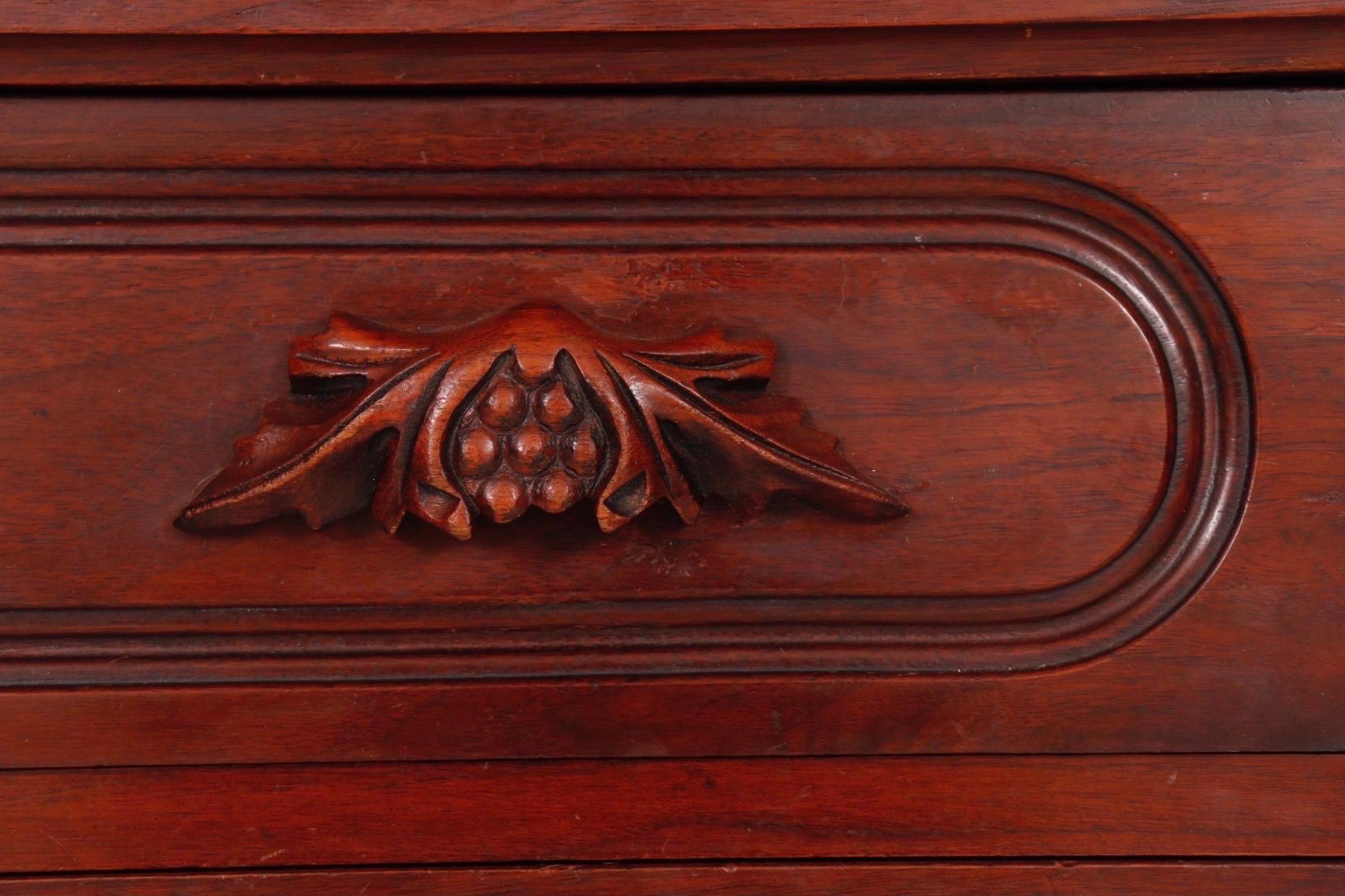 An American Victorian style standing chest of drawers made by Davis Cabinet Company of Nashville, Tennessee, for their Lillian Russel Bedroom collection. Hand dovetailed drawers open with grape and leaf carved handles inside cartouche beveled