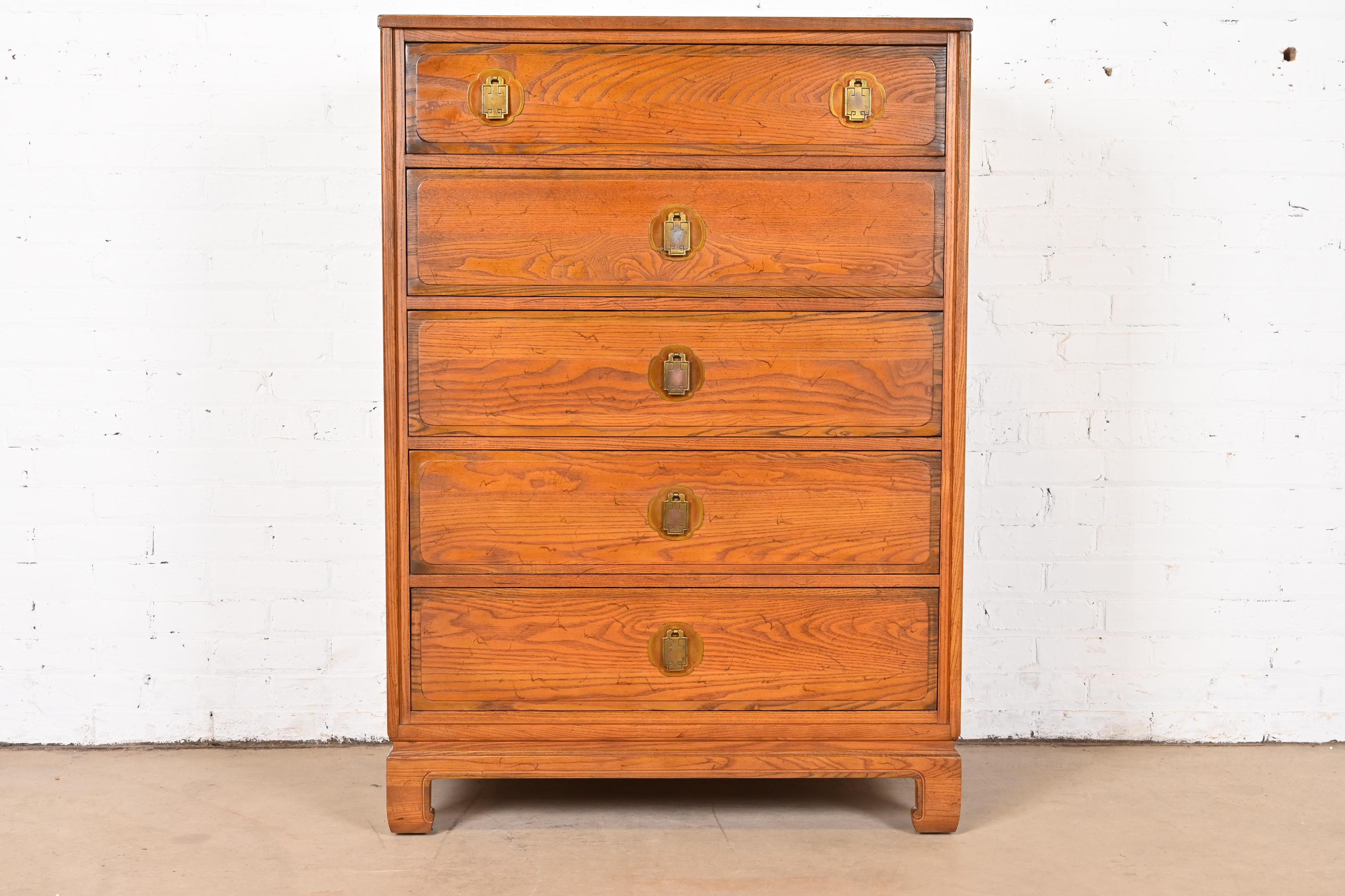 A gorgeous Mid-Century Modern Hollywood Regency Chinoiserie style highboy dresser or lingerie chest

By Davis Cabinet Company

USA, Circa 1960s

Carved oak, with original Asian inspired brass hardware.

Measures: 34