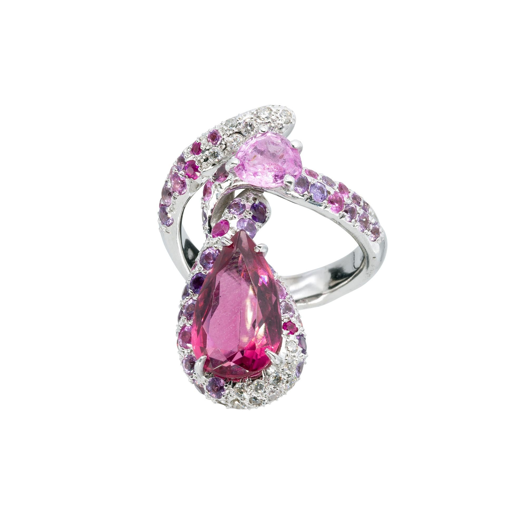A d'Avossa Ring ìn white 18 kt gold with a central pear shape pink tourmaline  cts 4.45, and a contour of a pink sapphire cts 1.05, and a pavé of white diiamonds cts 0.30 and pink sapphires cts 1.95
A Unique piece


Ref. Number ATR00659

