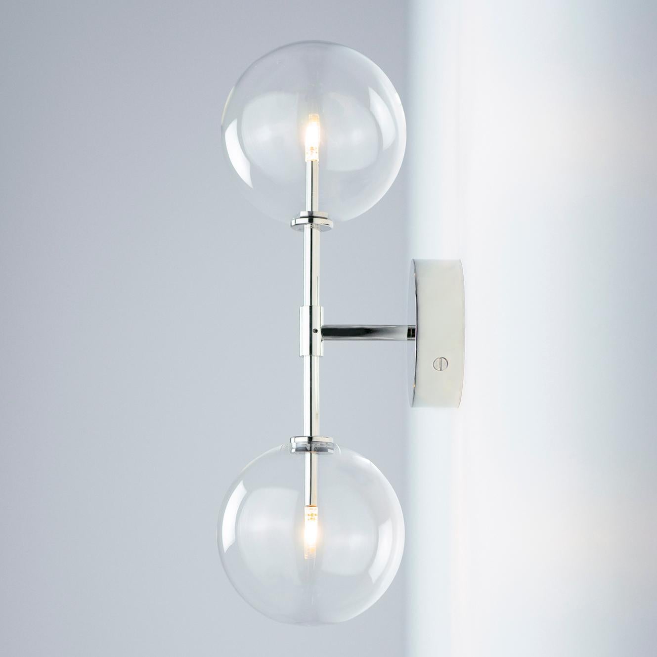 Dawn Dual Wall Sconce by Schwung
Dimensions: W 19 x D 15 x H 47.8 cm
Materials: Polished Nickel, hand blown glass globes

Finishes available: Black gunmetal, polished nickel and brass
Other sizes available.

Schwung is a German word, and