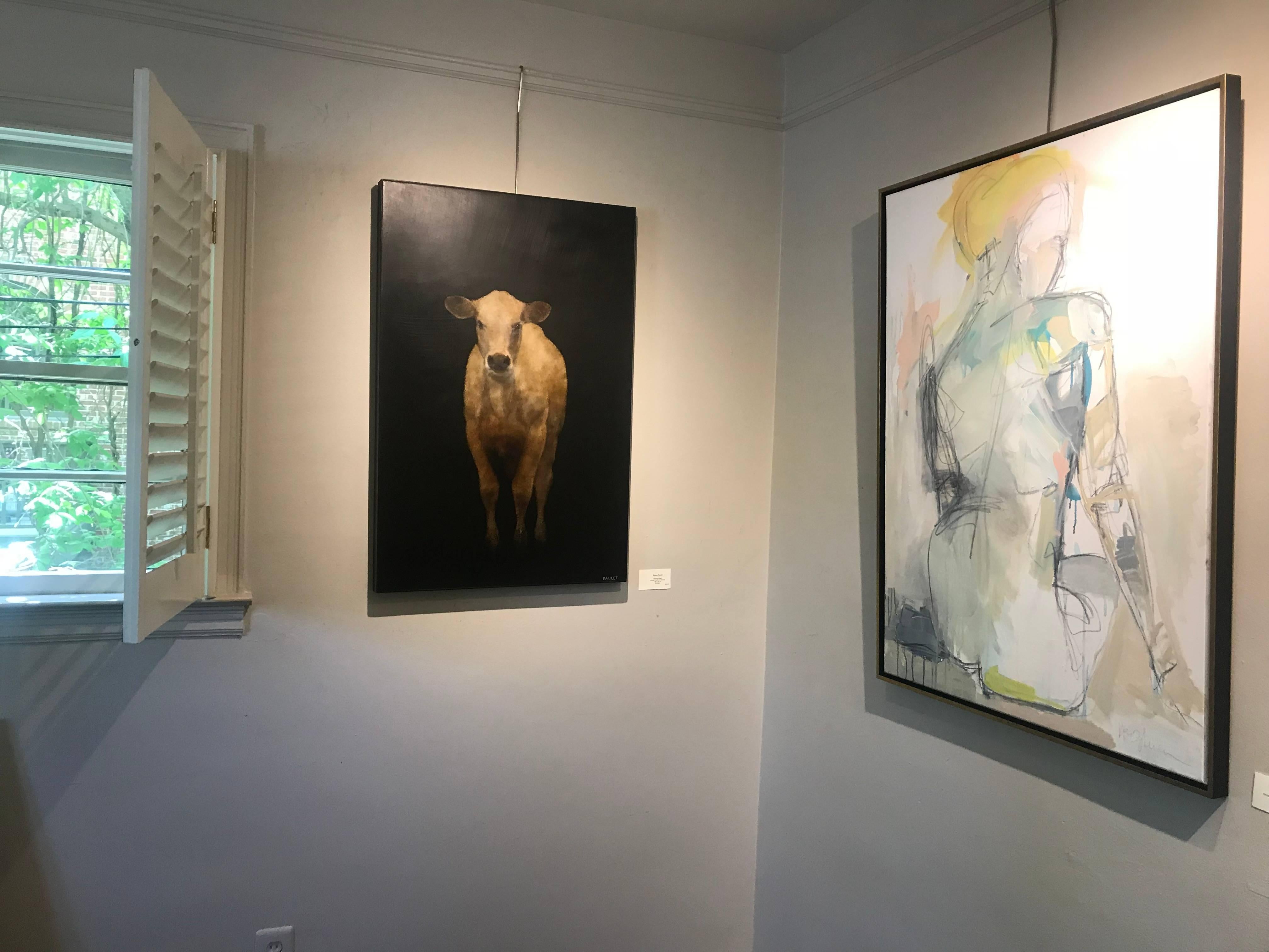'Bovine Belle' is a figurative mixed media on board cow painting created by American artist Dawne Raulet in 2018. Depicted on a solid black background allowing her to stand out beautifully, a cow is looking at us directly, inviting us in. She is