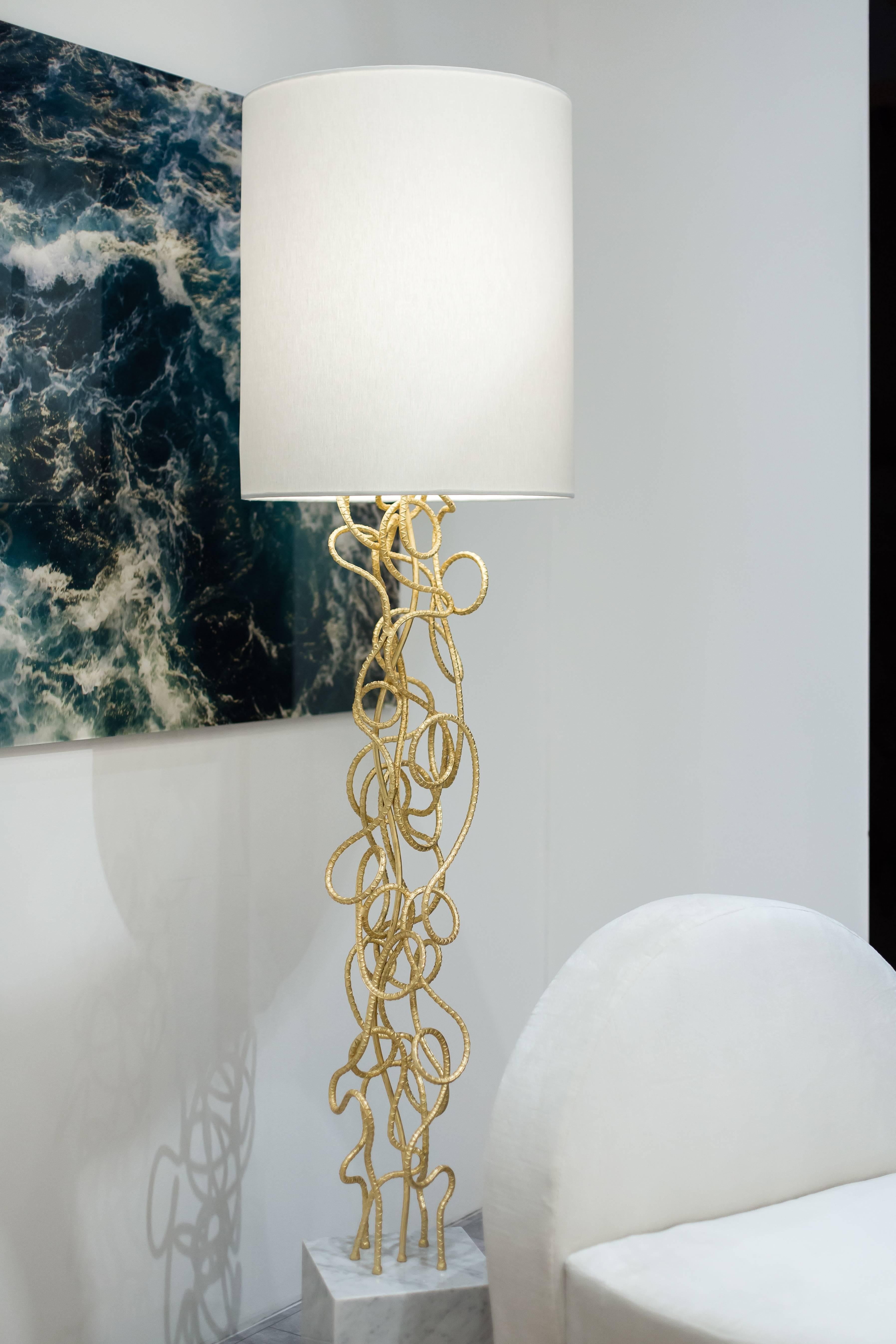 DAX FLOOR LAMP - Hand Twisted Rebar Modern Gold Leaf Floor Lamp w/ Carrara Marble Base

The Dax Floor Lamp is a stunning piece of artistry designed to create a sculptural statement in any room. It is crafted from hand-twisted gold-leafed rebar,
