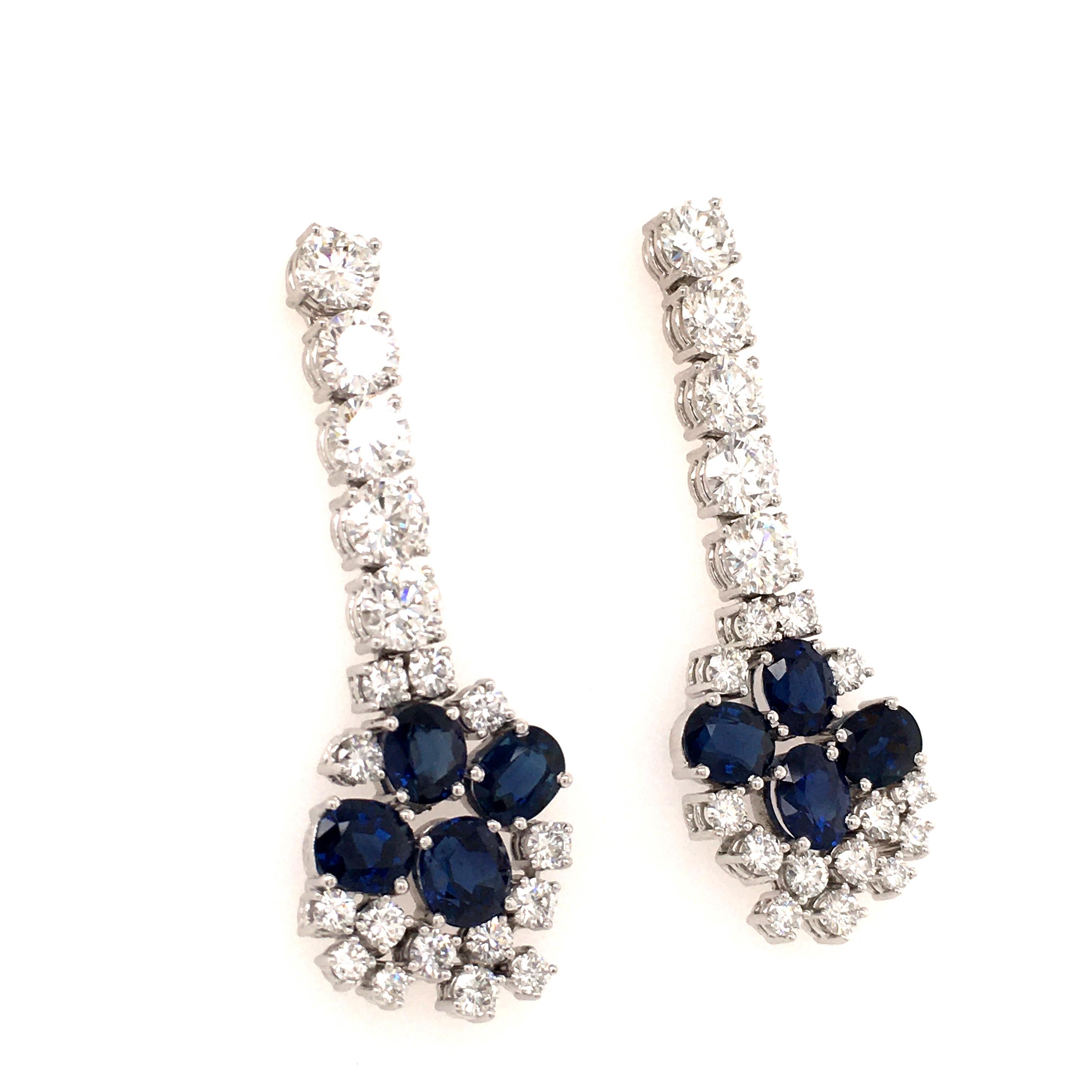 This beautiful pair of earstuds in 18 karat white gold is set with 8 oval shaped sapphires, total weight approximately 8.00 carats, and 40 brilliant-cut diamonds of G/H color. 
The upper ten diamonds are of vvs clarity and have a total weight of