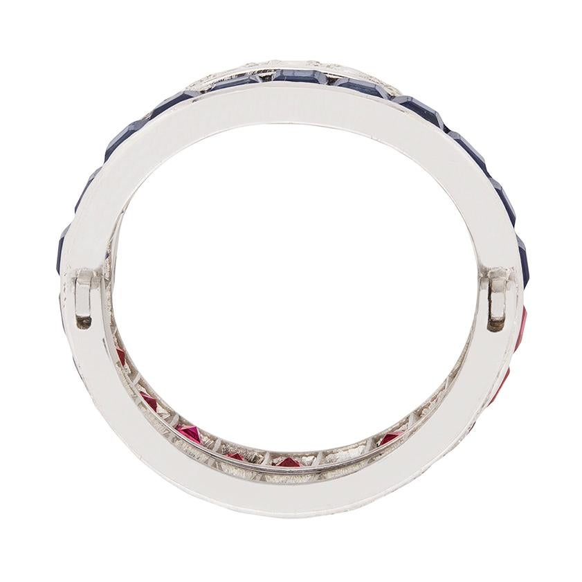A day and night ring features a central band made up of rubies and sapphires, and two further bands either side on hinges. They are grain set with diamonds and this ring contains transitional cut diamonds. Estimated as G in colour and VS in clarity