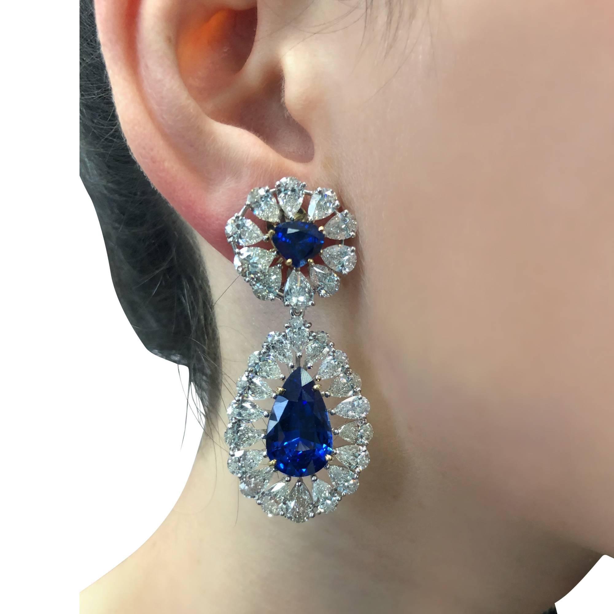 Spectacular day and night earrings featuring 2 perfectly matched vibrant blue pear shape AGL graded heated sapphires weighing approximately 16cts, suspended from 2 triangular cut sapphires weighing approximately 3cts, all surrounded by 56 pear shape