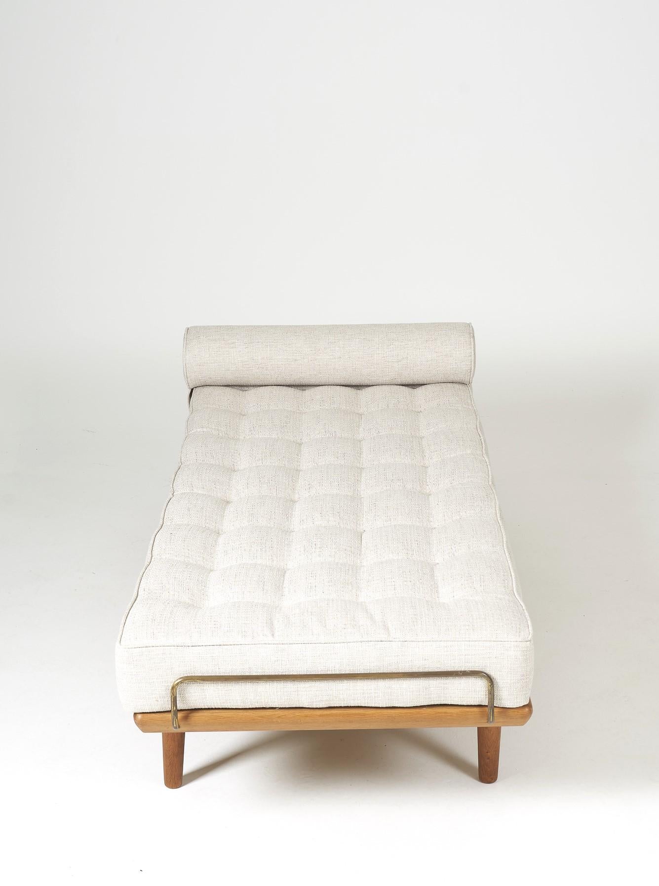 Day Bed model GE19 by the Danish designer Hans J.Wegner published by Gemata, in 1956. Solid teak structure, tapered legs and brass mattress support. Mattress and bolster entirely upholstered in high quality fabric.