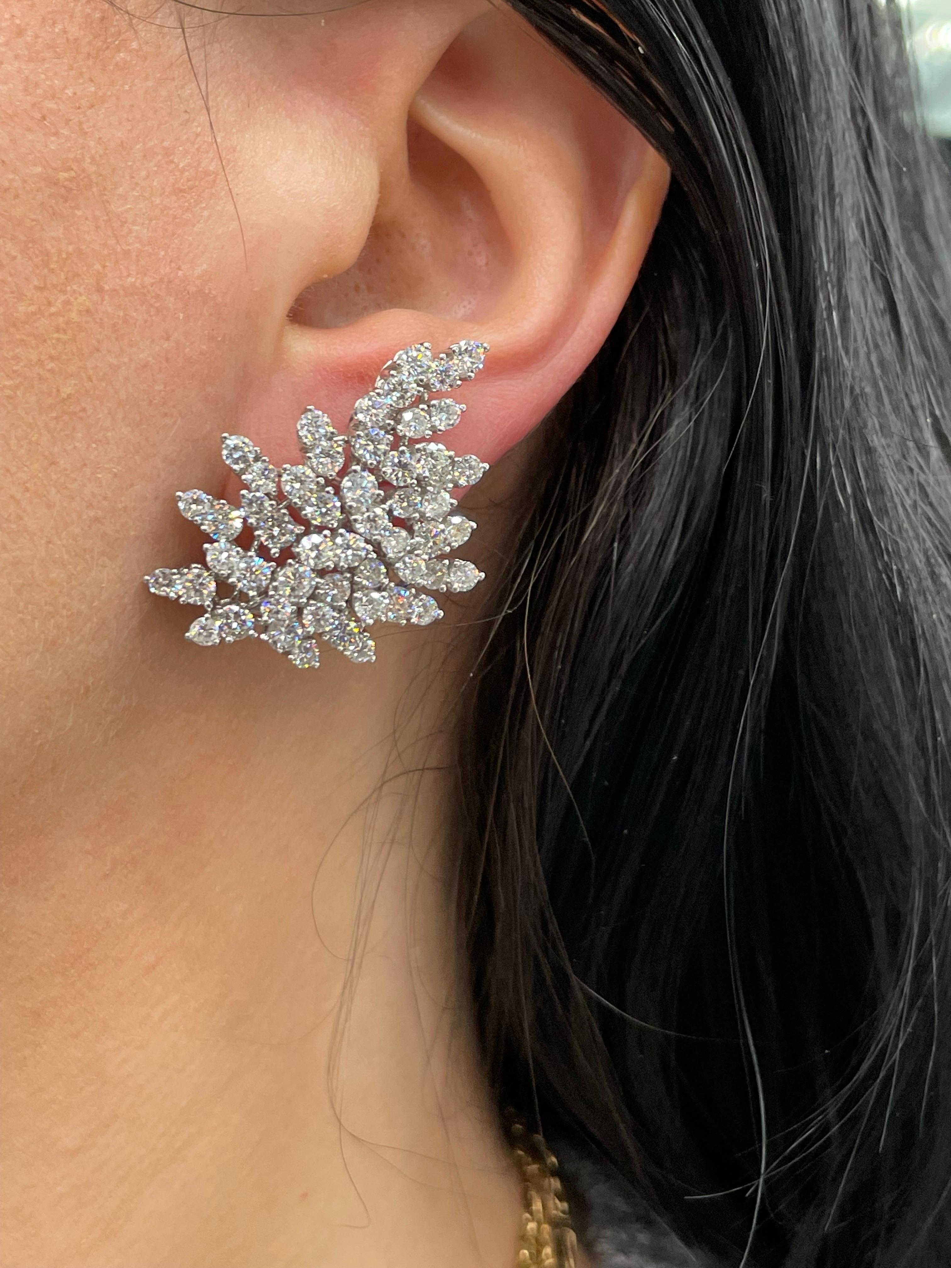Diamond Starburst cluster earrings featuring 104 Round Brilliants weighing approximately 9.50 Carats, in 18 Karat White Gold.
A gold hoop behind the ear to add a Pearl, Gemstone drop.
Color G-H
Clarity SI