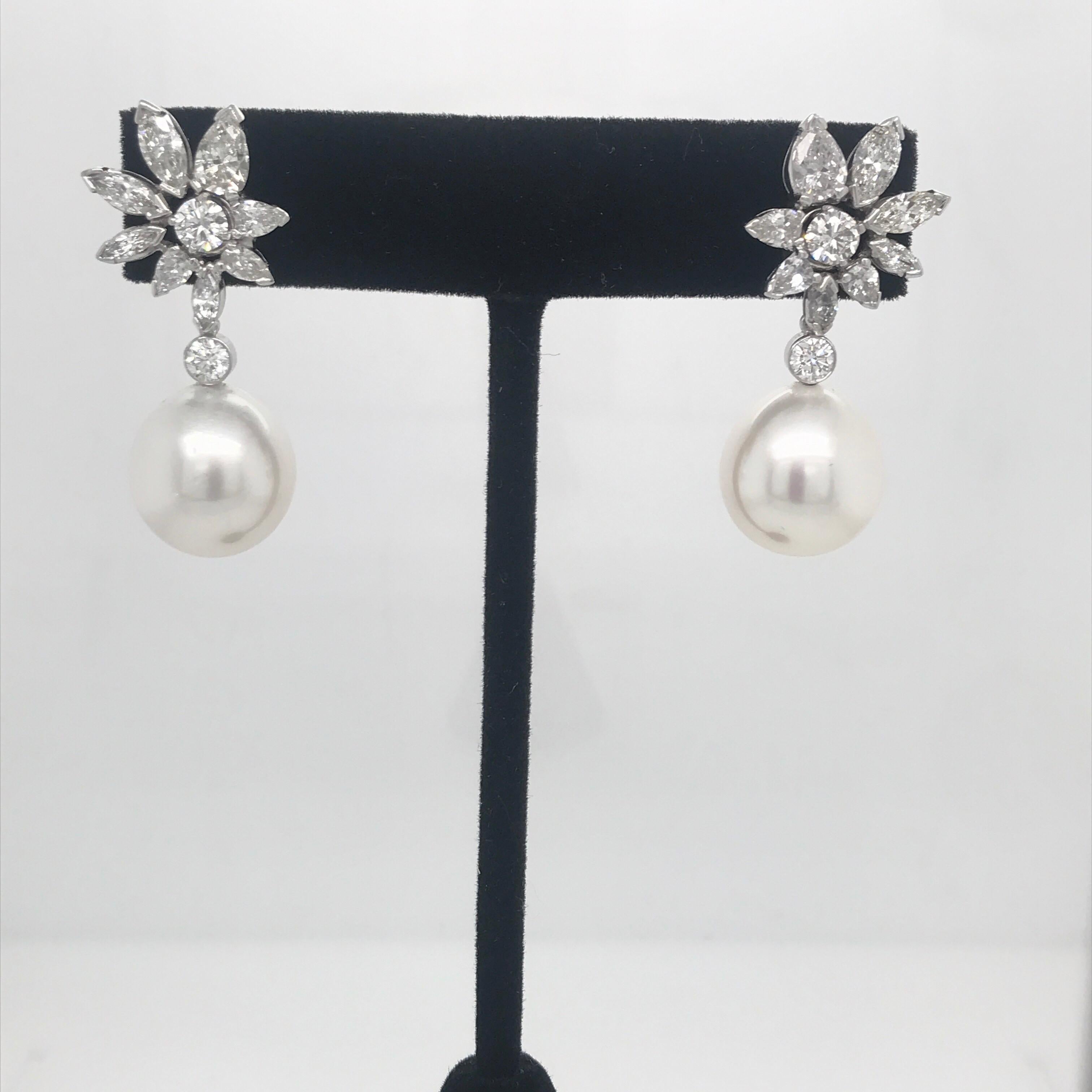 Day & Night Earrings featuring a diamond cluster of pear, marquise and round brilliants weighing 5.06 carats and two South Sea Pearls measuring 13-14 MM, in 14K White Gold. 