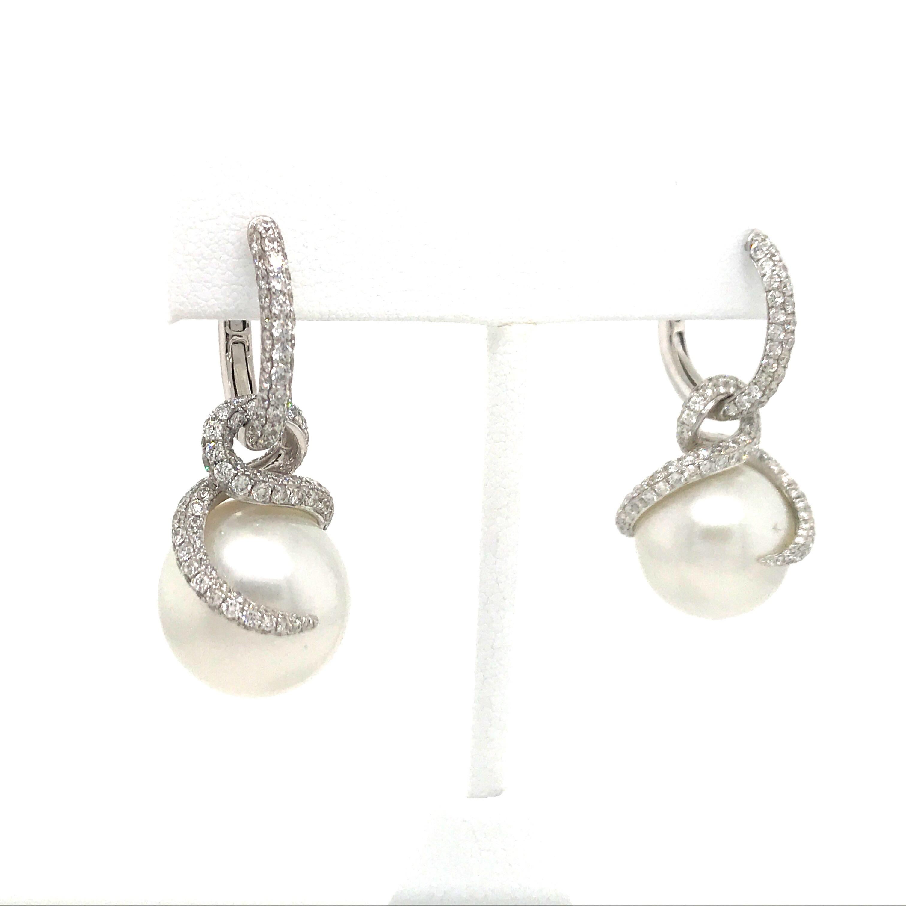 18K White gold earrings featuring two pearls measuring 15 mm and a diamond flame motif weighing 3.98 carats. Top of the earrings can be worn alone as a hoop. 
Color G
Clarity VS-SI

Hoop measures 0.75 inches