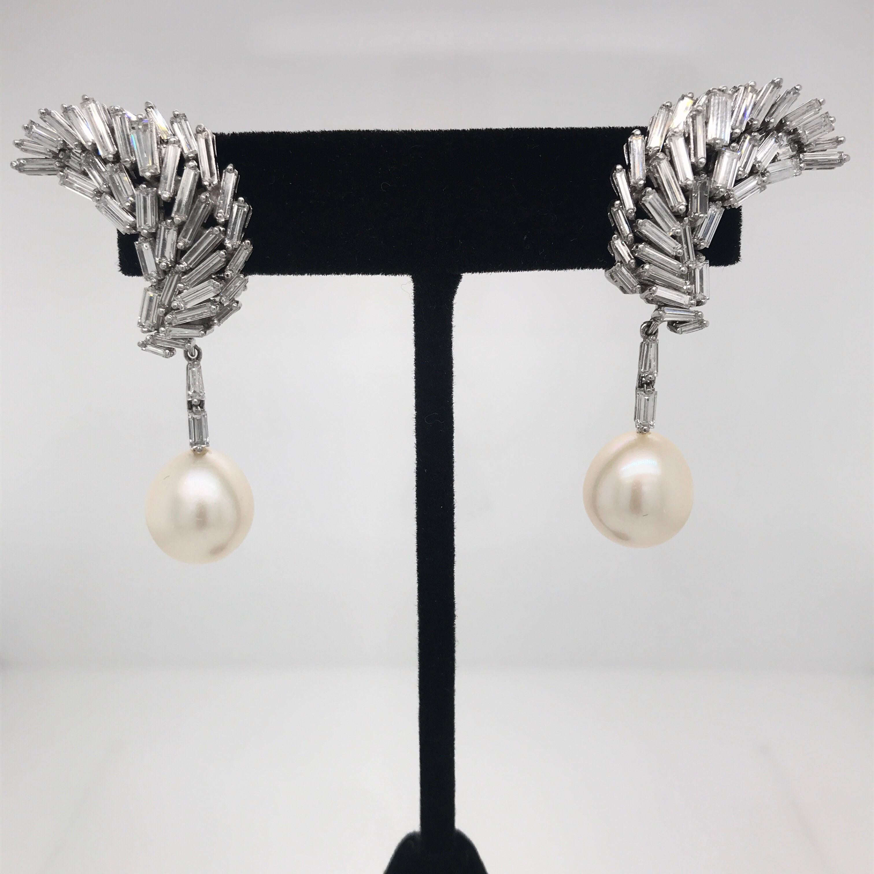 Striking Day & Night Earrings featuring 78 diamond baguettes weighing approximately 8 Carats with two pearls measuring 11-12 MM, crafted in Platinum. 