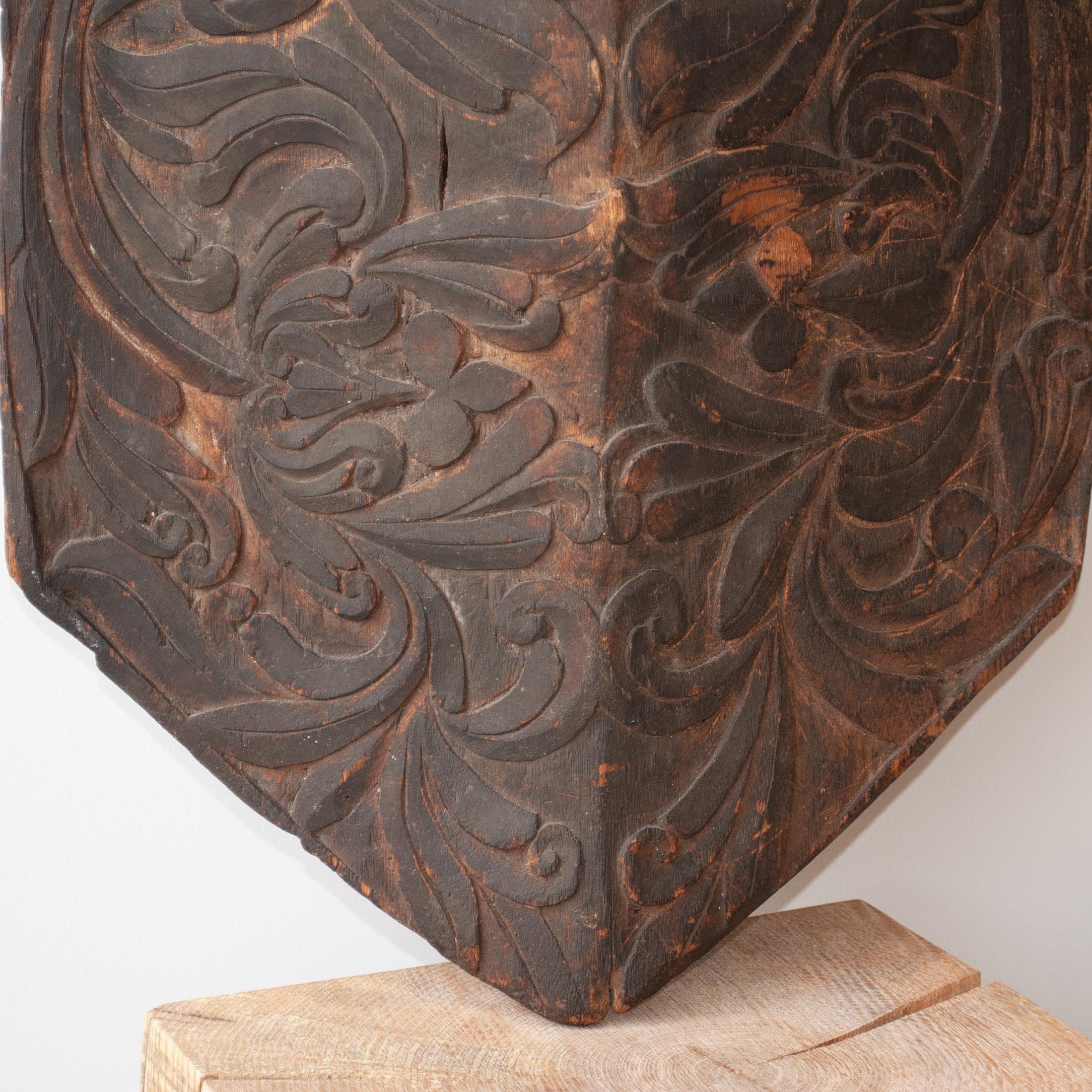 A rare hand carved Dayak tribal shield from Kalimantan/Borneo, Indonesia. These shields were made by the Dayak Iban tribes for real fighting use and ceremonial rites. Wonderfully carved with swirling tribal motifs from the local Jelutong wood. The
