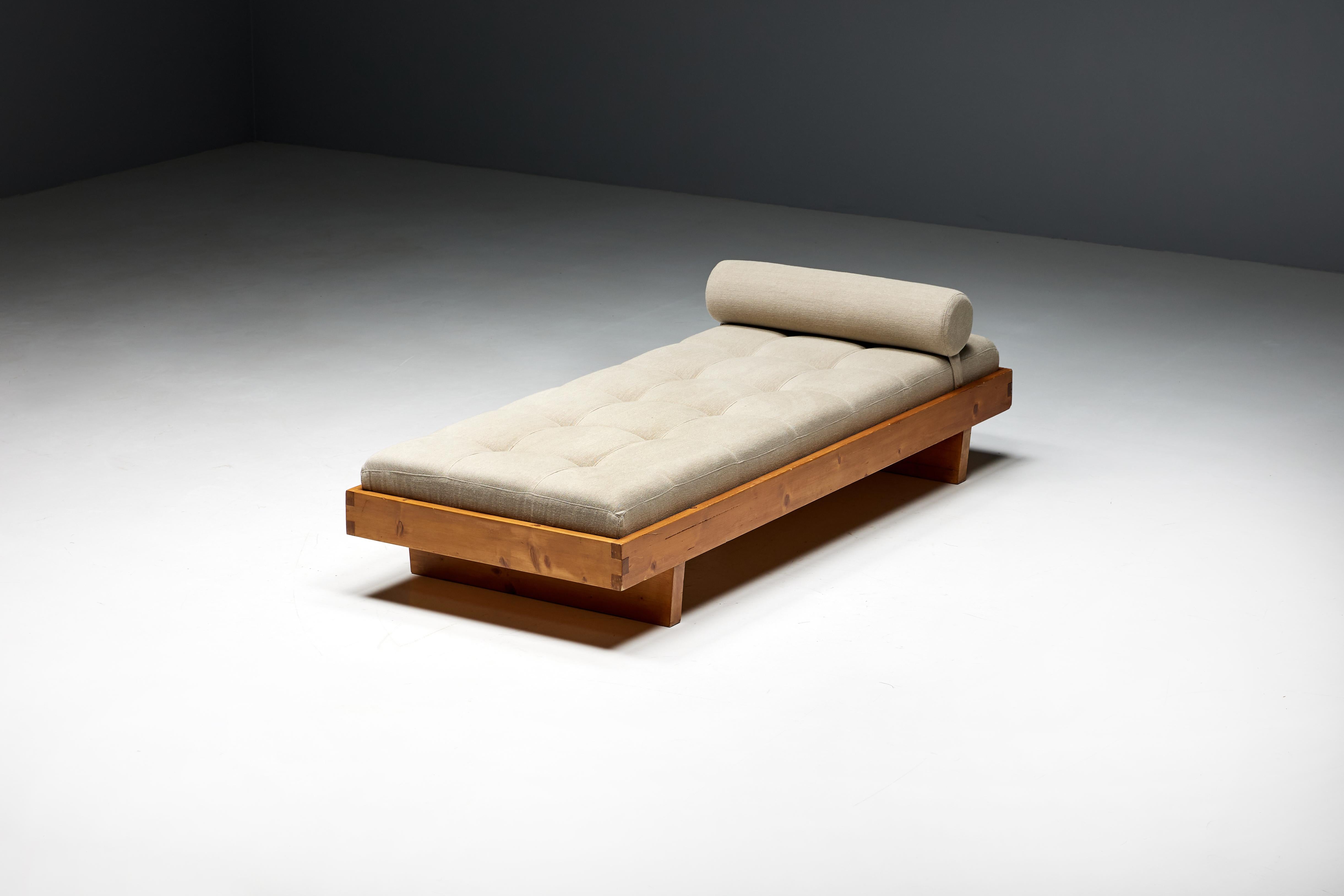 Daybed designed by Charlotte Perriand in the 1950s for the chalets of Méribel Les Allues, France. This masterpiece of design embodies the perfect harmony between functionality and aesthetics. Crafted from pine wood, the daybed exudes the warmth of