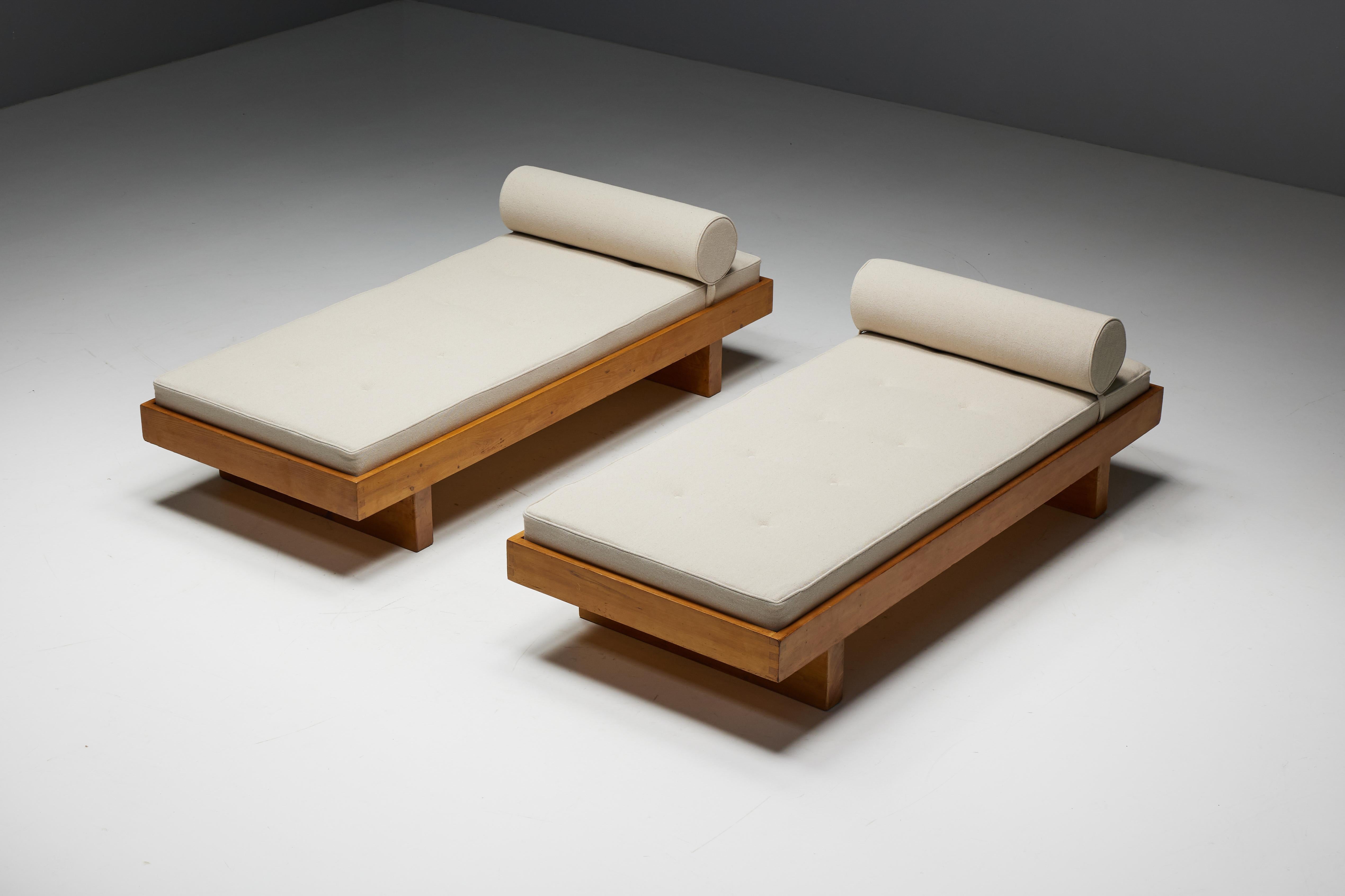 Daybed designed by Charlotte Perriand in the 1950s for the chalets of Méribel Les Allues, France. This piece of furniture is a testament to Perriand's timeless design ethos, combining functionality with the warmth of handcrafted pine wood. The