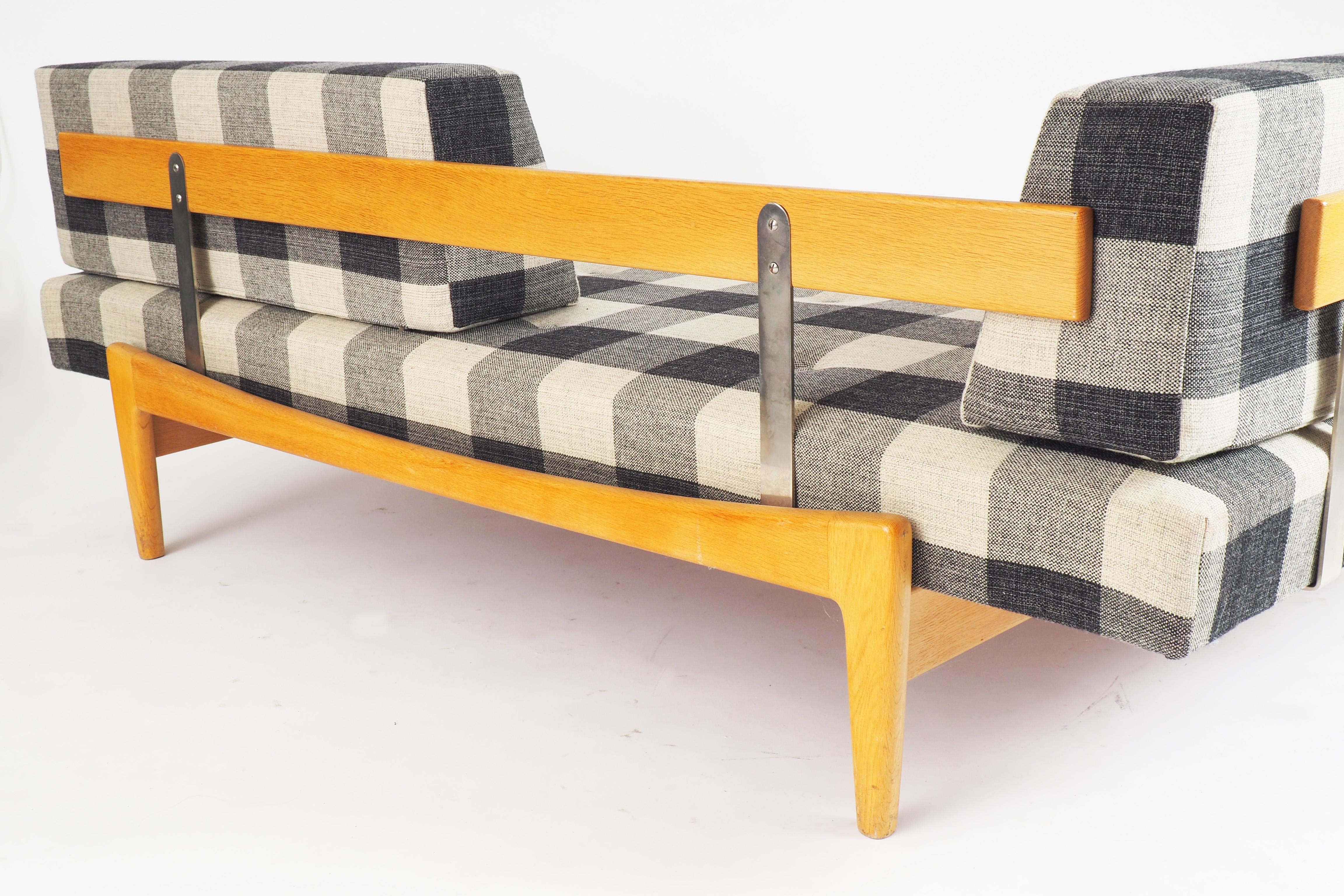 Daybed in excellent condition by Ib Kofod-Larsen for Seffle Möbelfabrik. Solid oak and original wollen fabric.
 