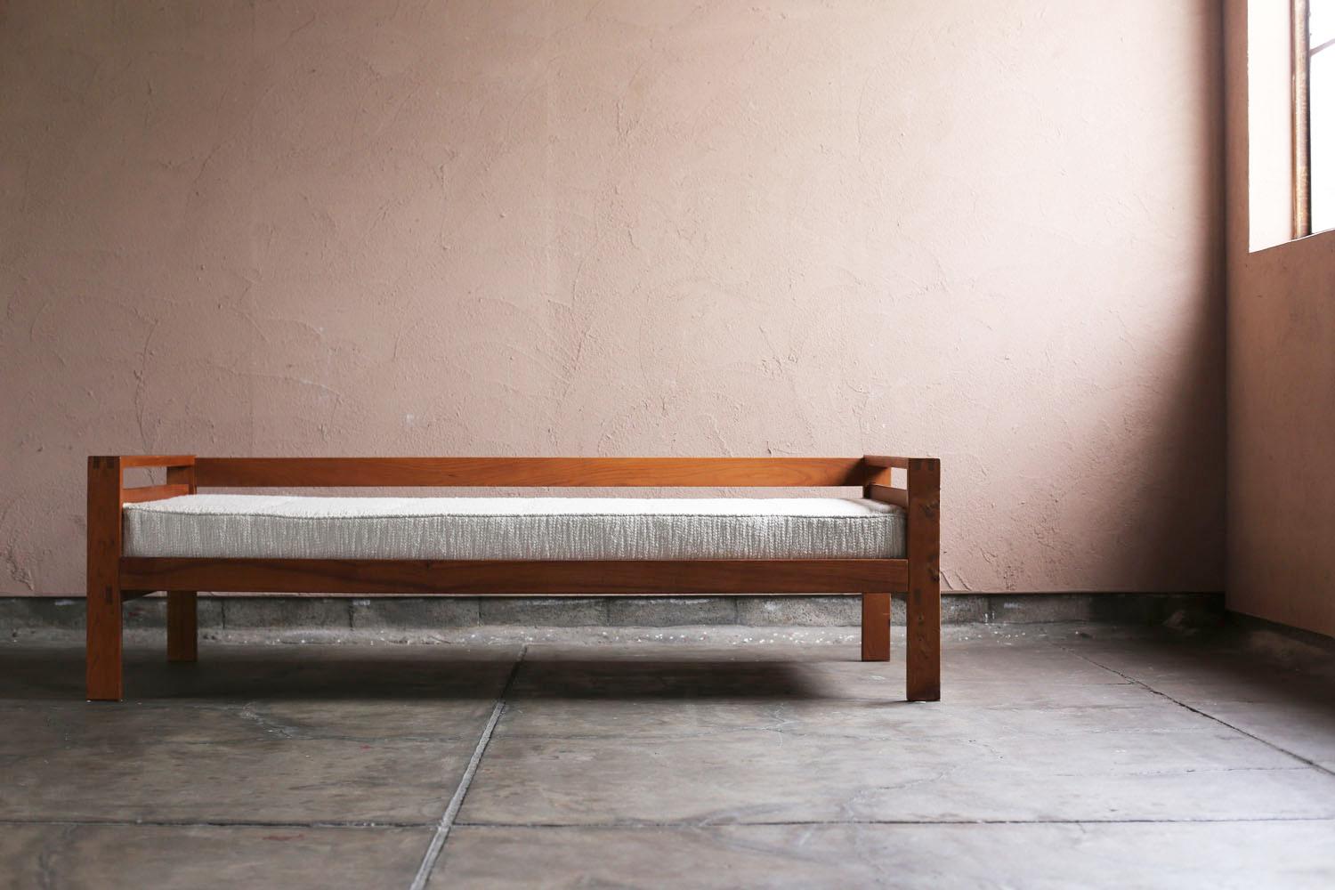 A vintage daybed designed around 1960 by French designer Pierre Chapo. The model name is L06A. The mattress has been reupholstered with high-quality bouclé fabric. It has an assembly type design using bolts.