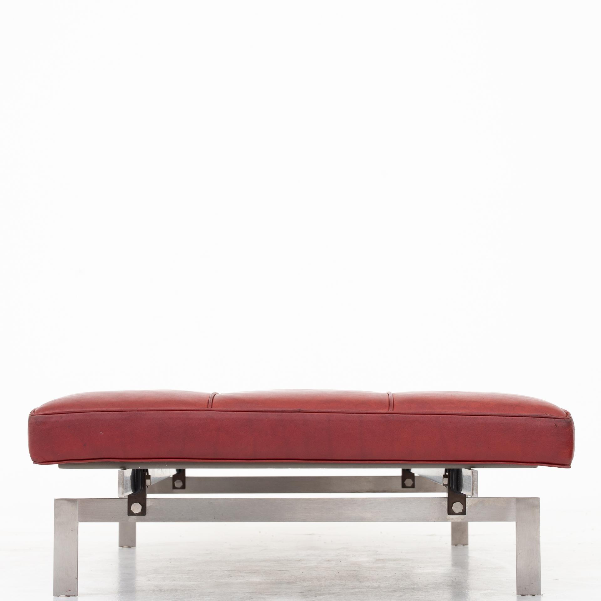 PK 80 daybed in Indian red leather on a frame of brushed steel. Maker Fritz Hansen.