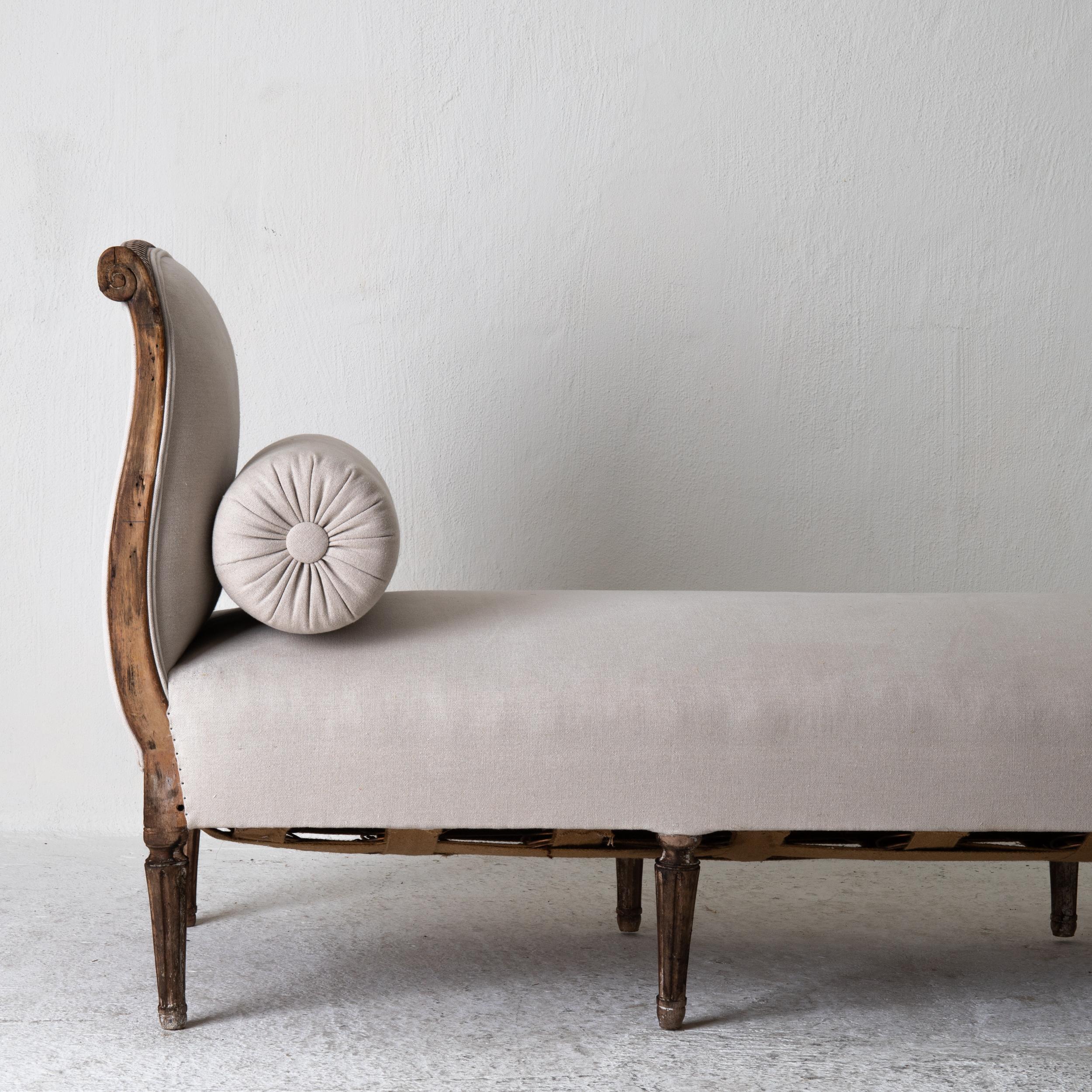 A daybed made during the early part of the Gustavian period in Sweden, 1780-1800. Frame made from dark stained wood carved with ribbon beading and flowers. Rounded and channeled legs. Upholstered in a neutral colored linen.

  