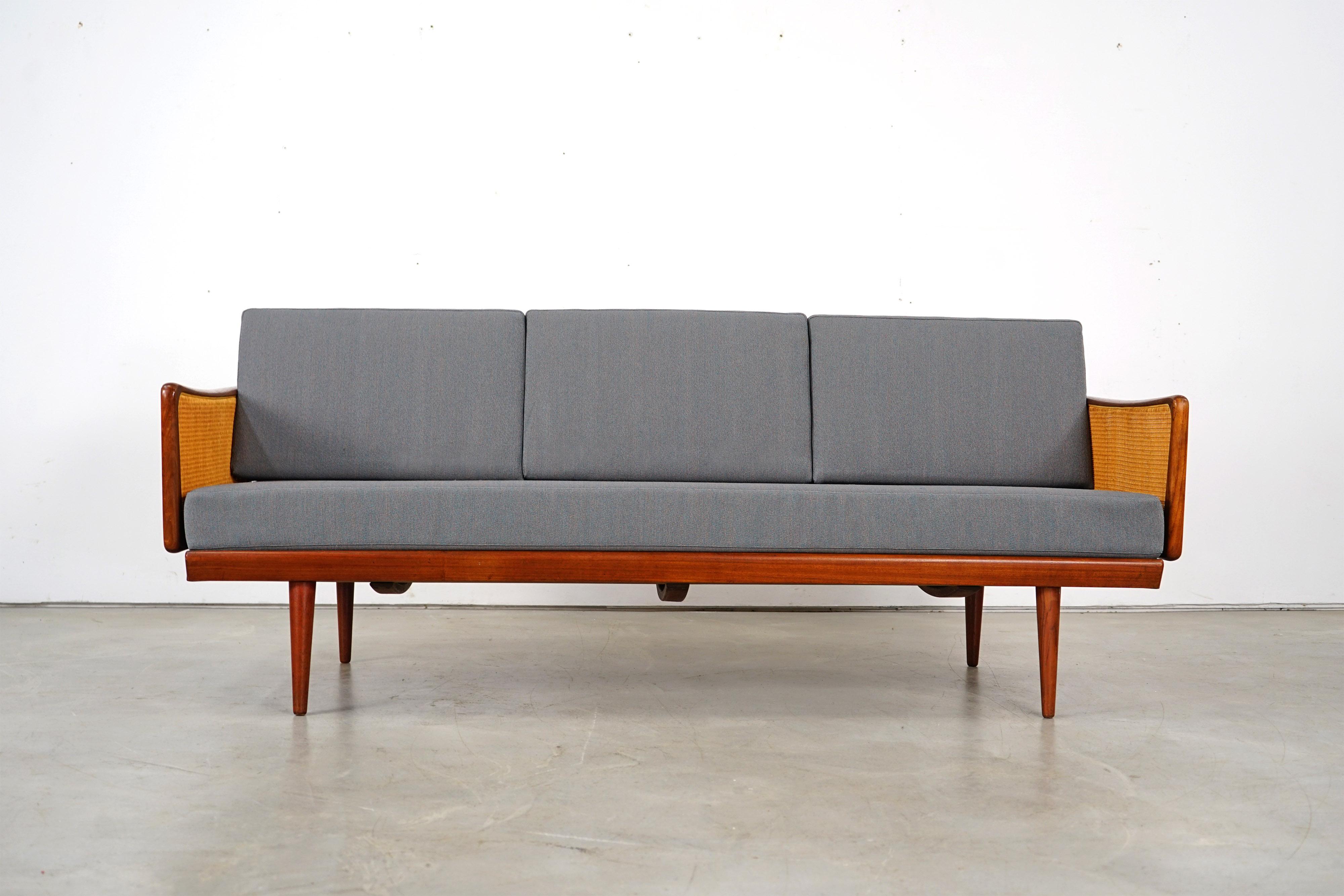 Rare classic of Scandinavian furniture by Peter Hvidt & Orla Mølgaard Nielsen. Teak and wicker frame. New foam upholstery covered with a beautiful fabric by ROHI. The daybed was produced by France & Søn in the 1960s. It is in every good condition.