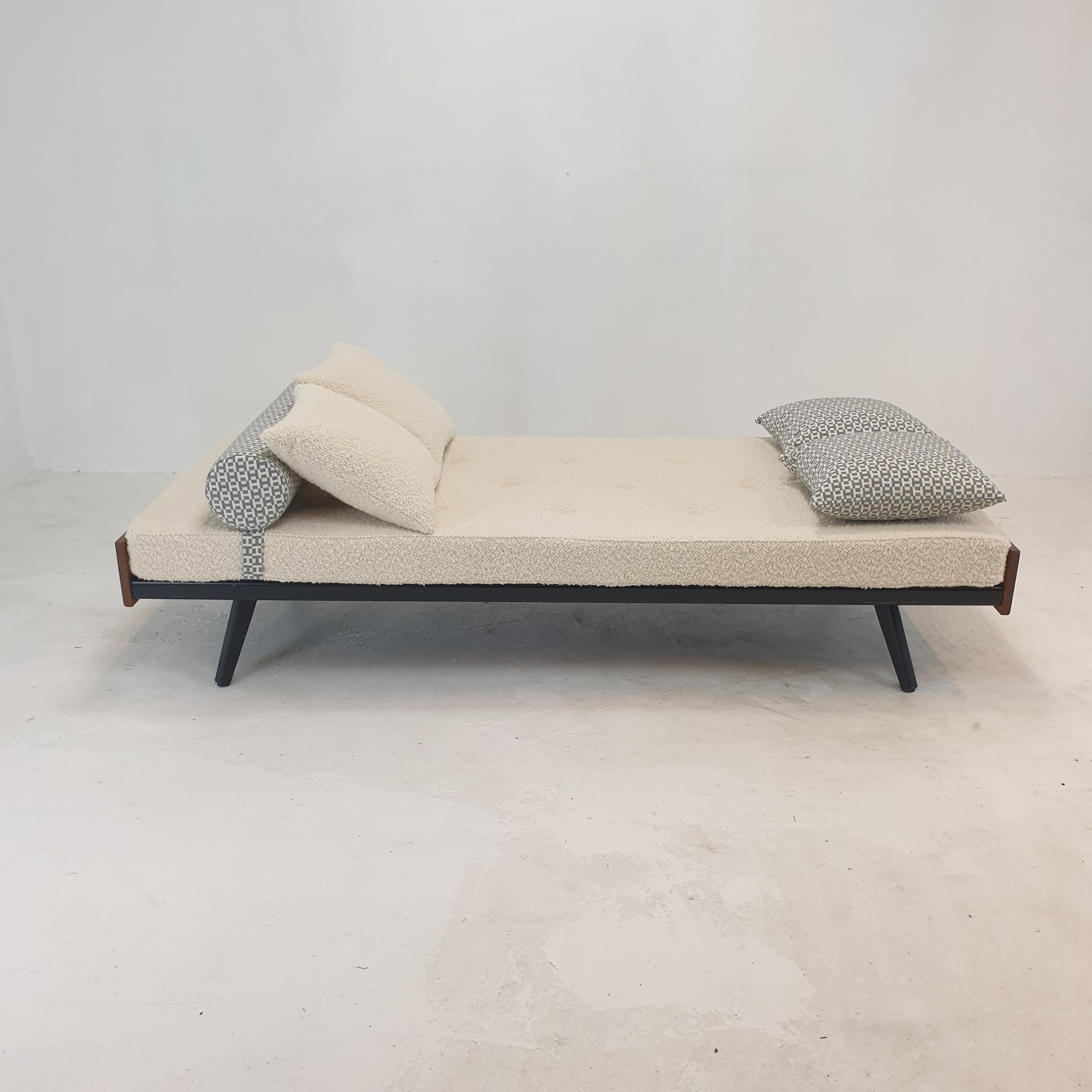 Very nice daybed, fabricated in The Netherlands in the 60's. 
It has 4 folding feet, see the last 2 pictures.

The mattress is renewed with new foam and it has just been upholstered with lovely wool fabric, the same for two cushions.

The